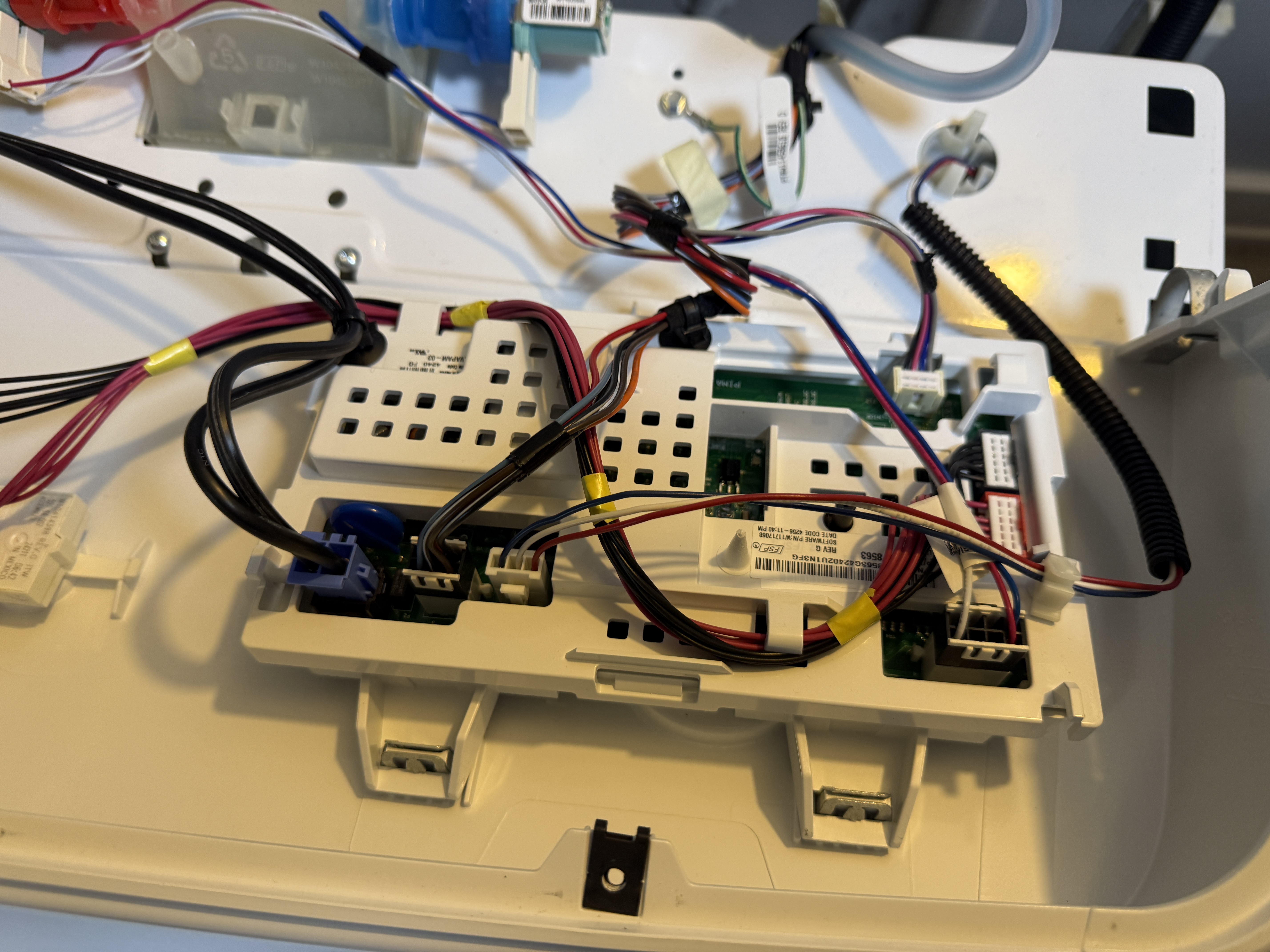 Control board removed from the Amana washer, showing the wiring harness