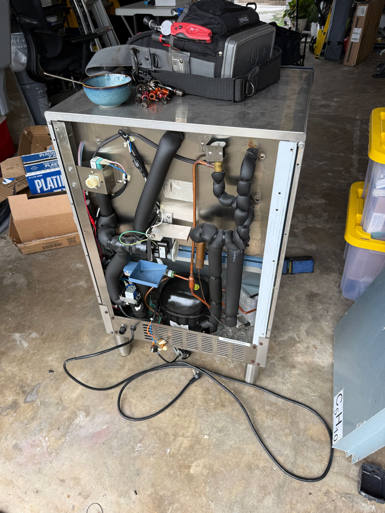 Top-down view into the ice machine cabinet showing the compressor and fan assembly