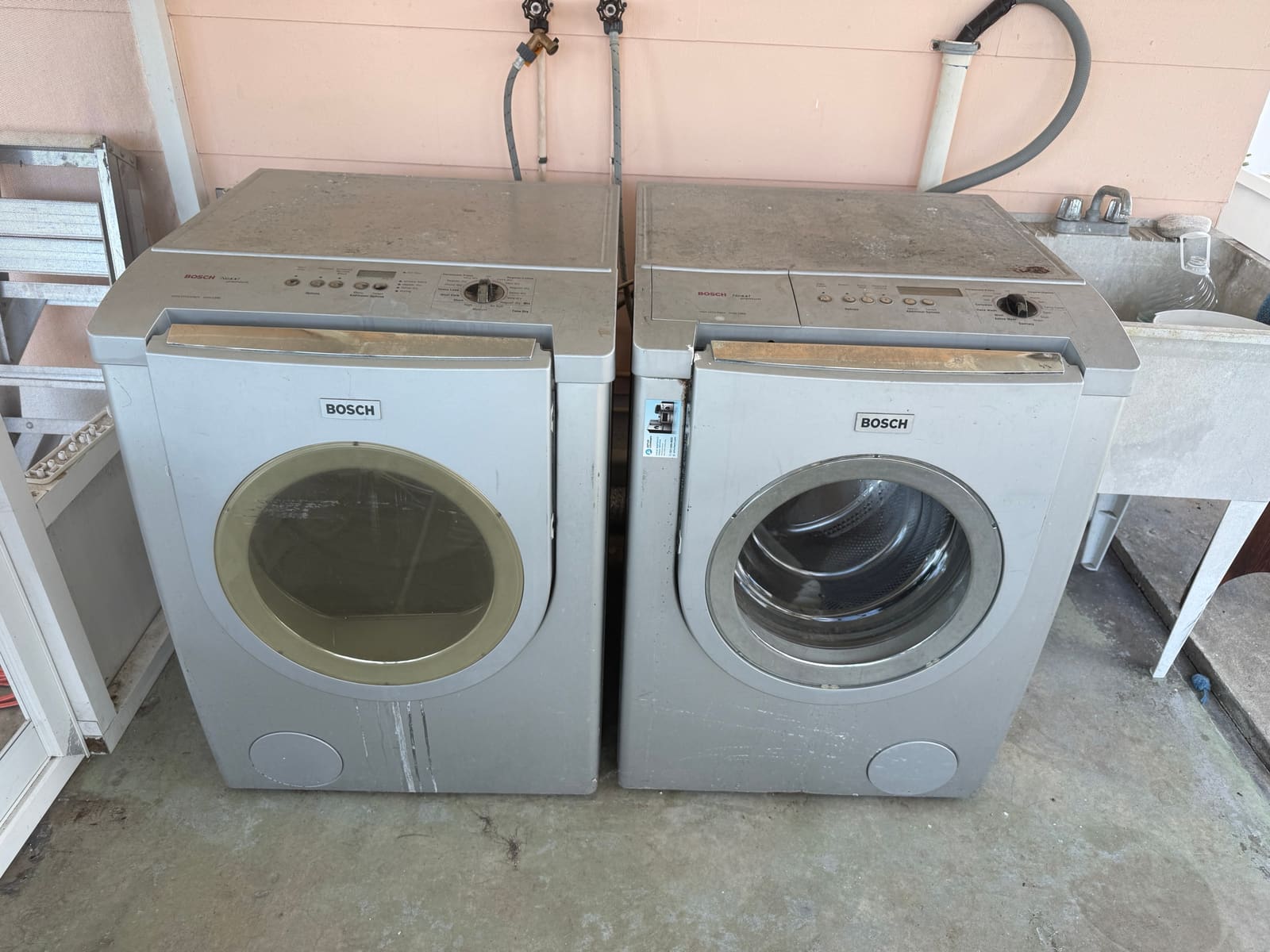 Older Bosch stackable washer and dryer set installed outdoors at a rental house in Clearwater