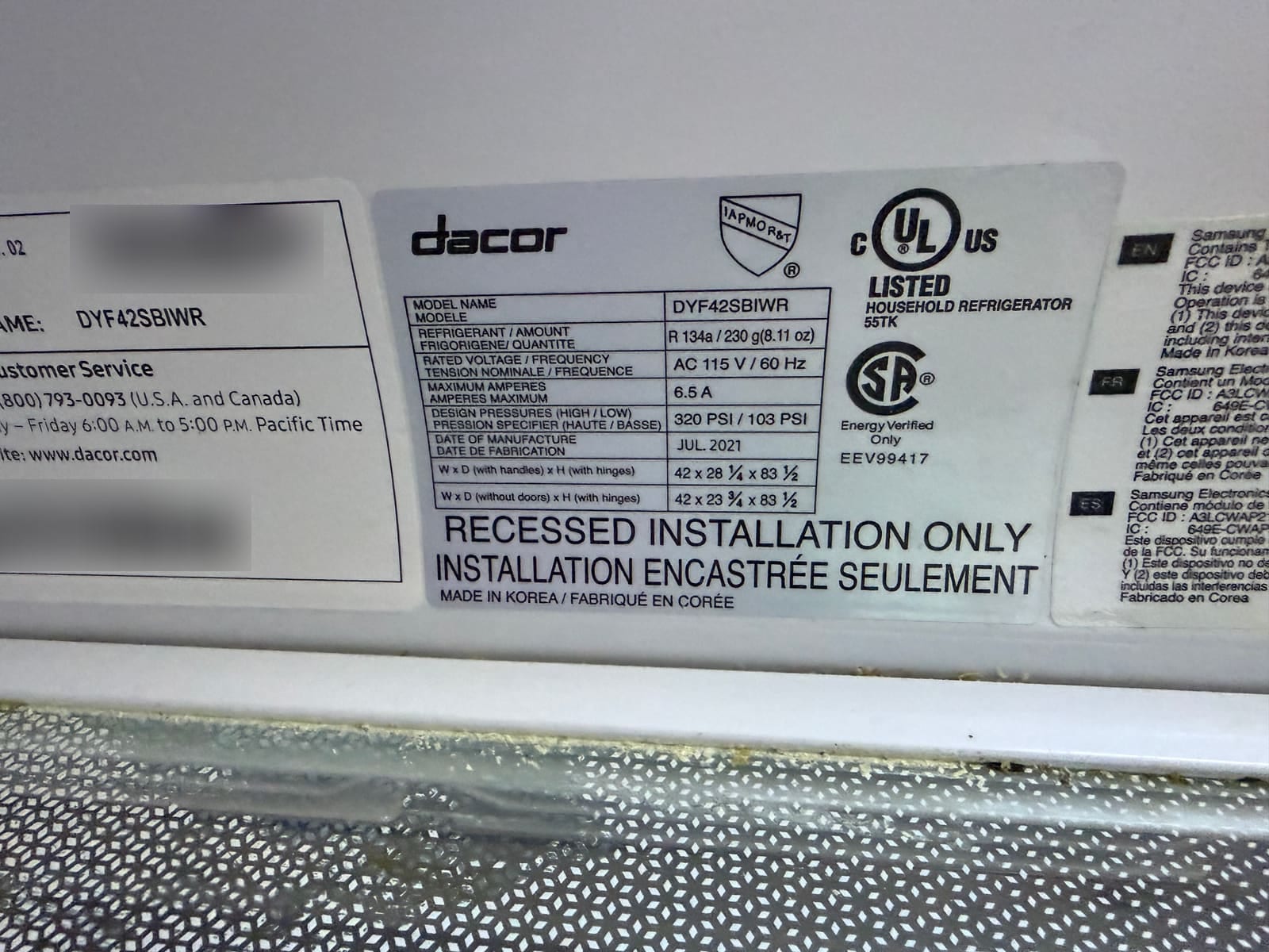 Dacor refrigerator data plate with model DYF42SBIWR readable; serial number and barcodes blurred