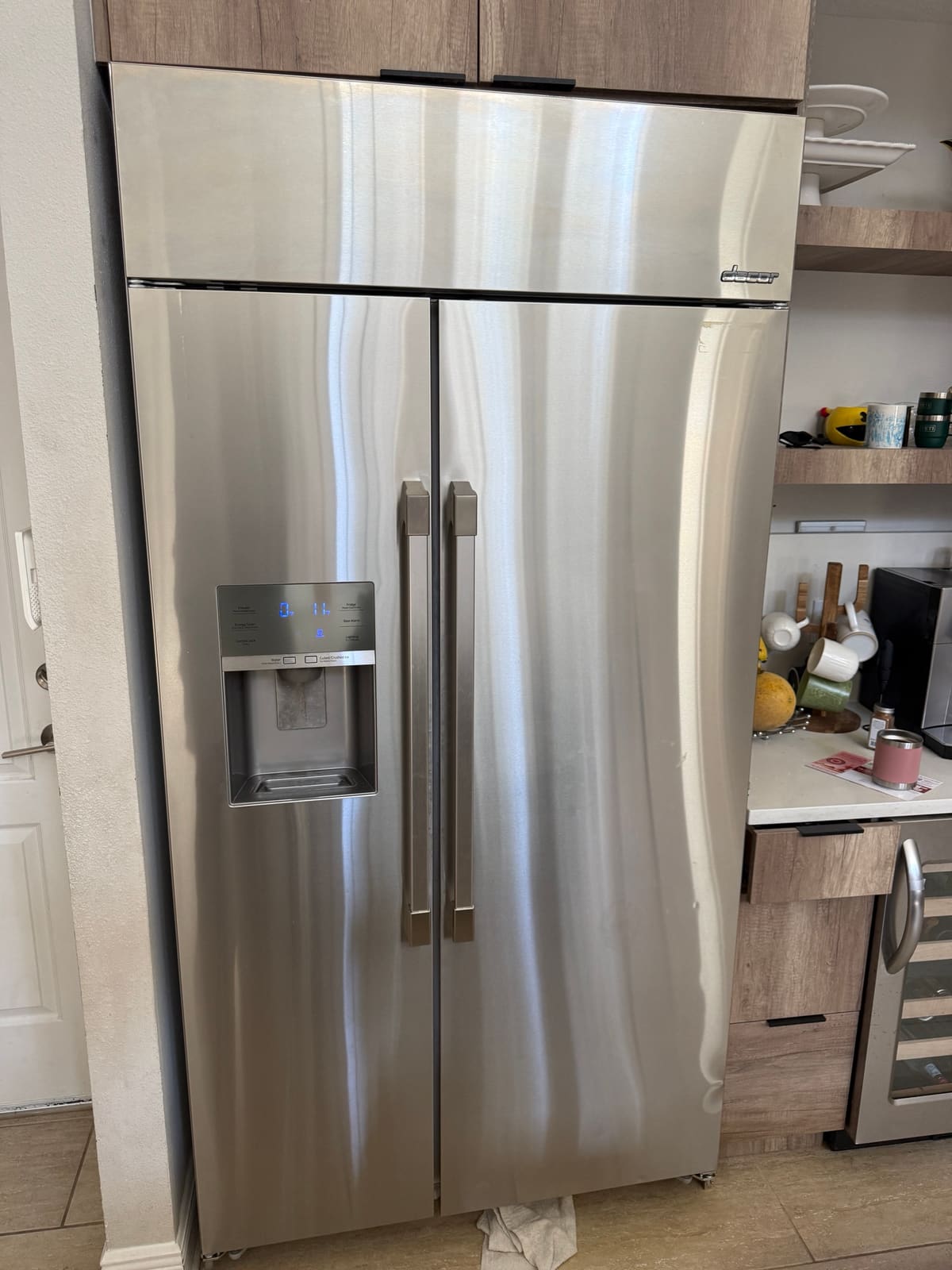 Stainless Dacor built-in side-by-side refrigerator with an ice and water dispenser in a Beach Park, Tampa kitchen