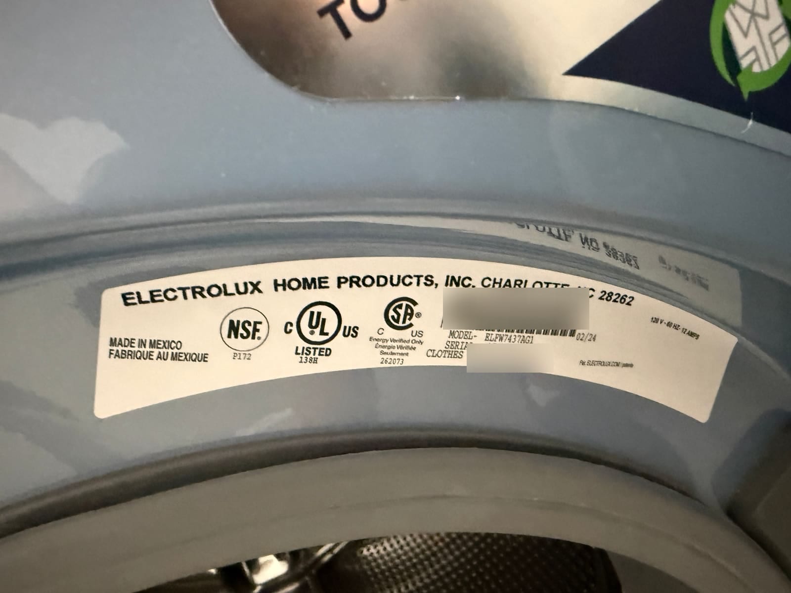 Electrolux washer data plate showing model ELFW7437AG1, made in February 2024