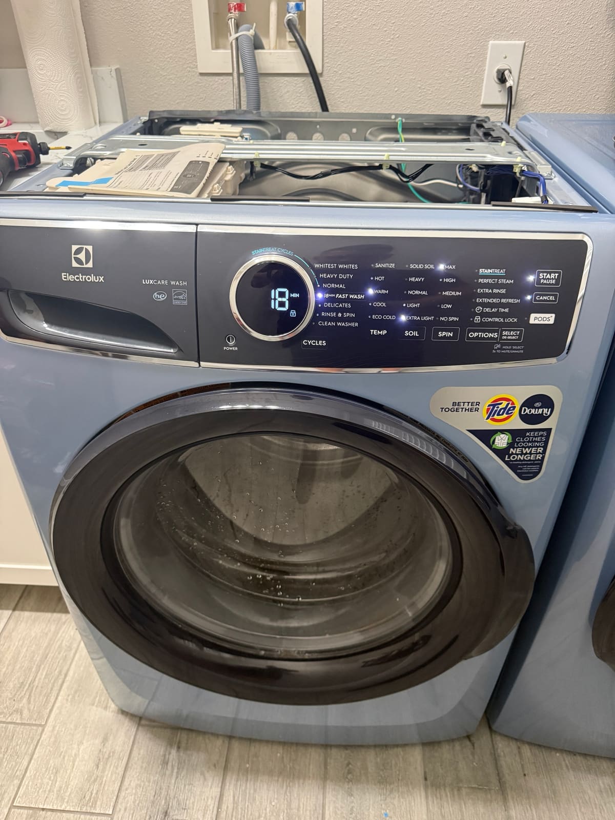 Electrolux washer running an 18 minute fast wash after the repair, with water visible in the drum