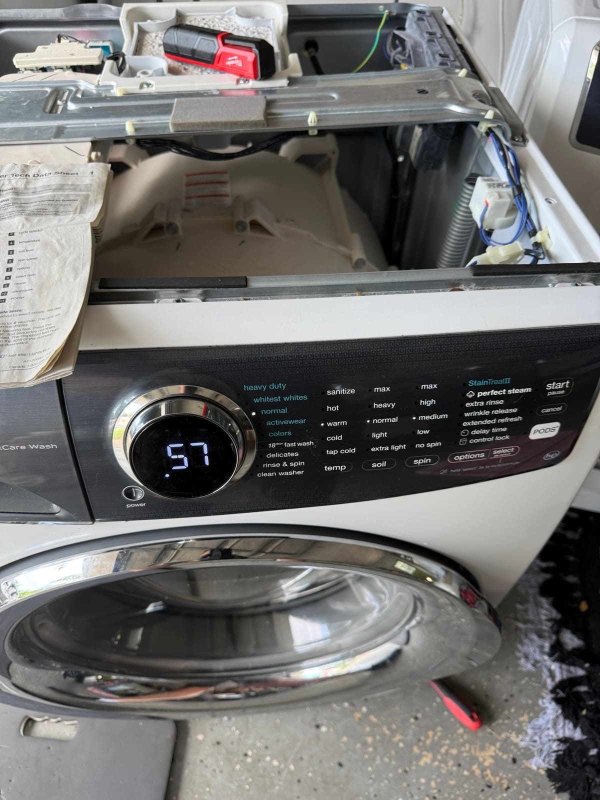 Electrolux washer display showing error 57 during test mode, with the top panel removed