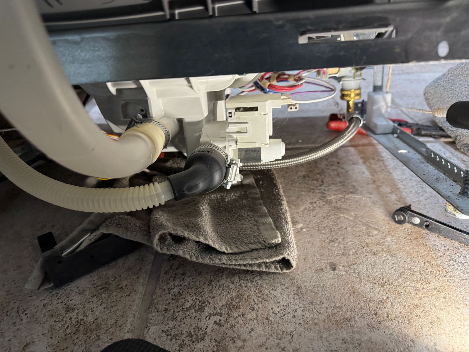 New circulation pump installed under the Frigidaire dishwasher