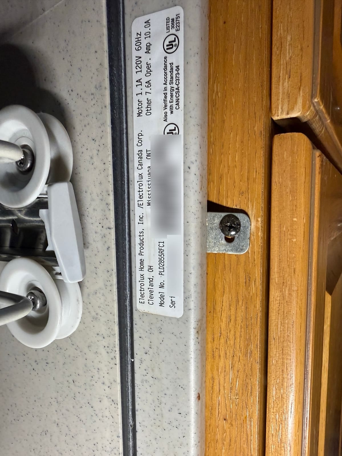 Dishwasher data plate with model PLD2855RFC1 readable; serial number and barcodes blurred