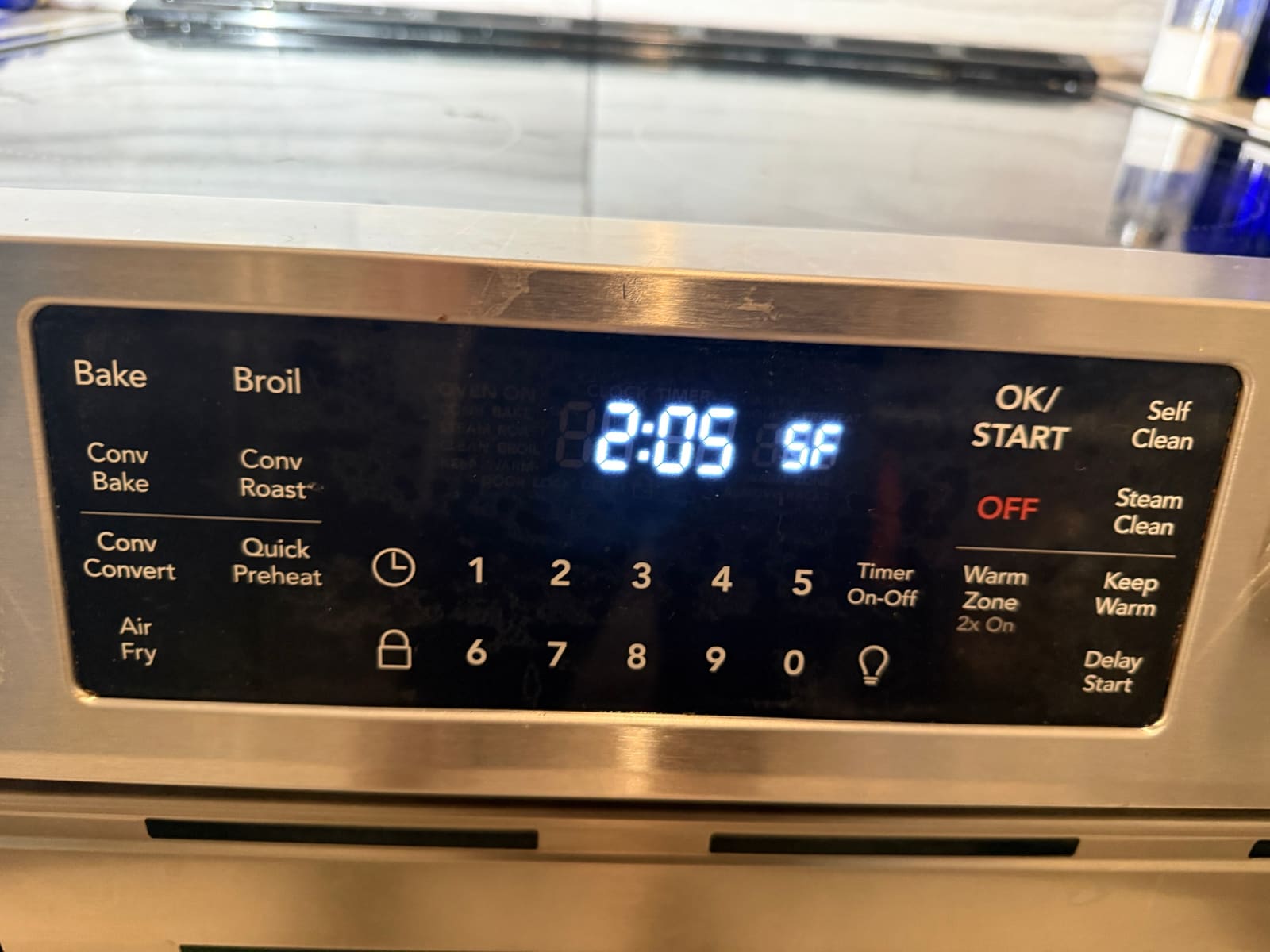 Frigidaire range control panel with SF showing next to the clock on the display