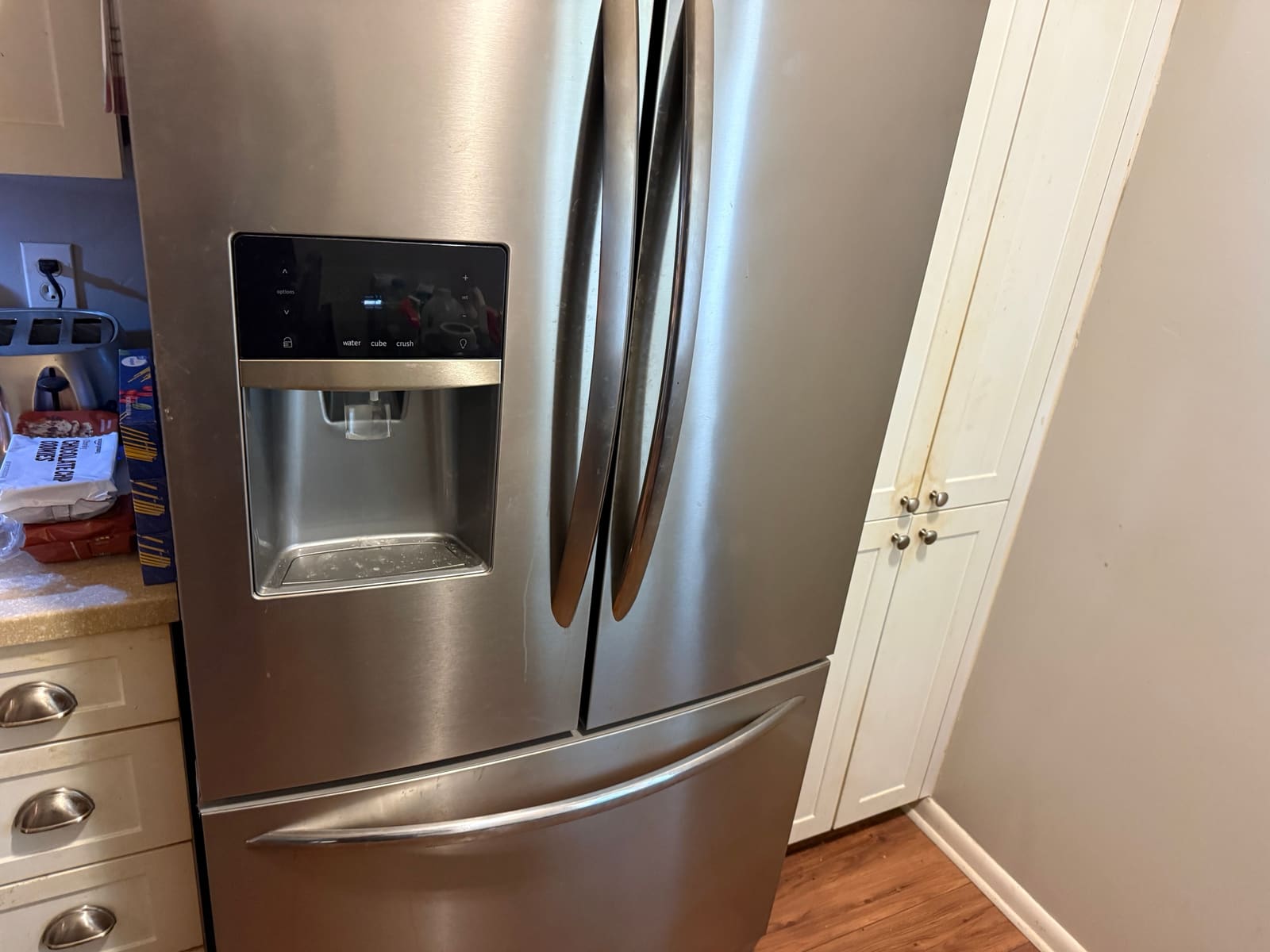 Stainless steel Frigidaire Gallery French door refrigerator with a door dispenser in a kitchen in Palm Harbor