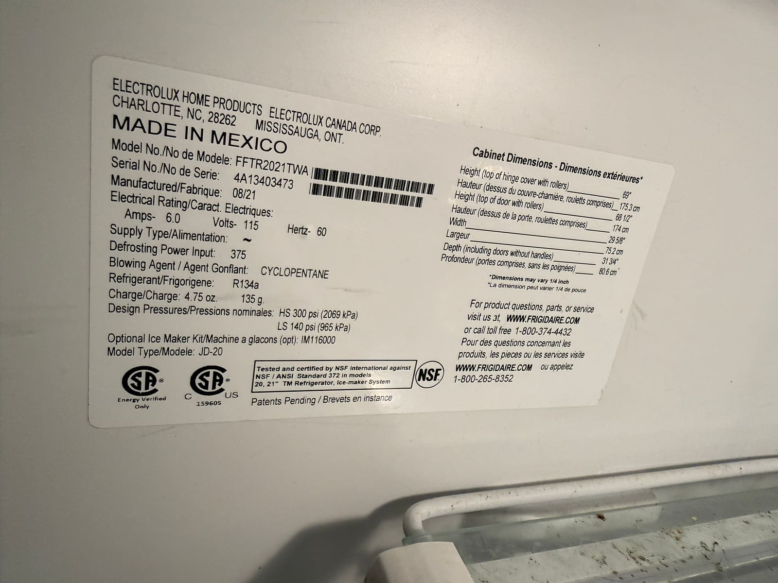 Frigidaire data plate showing model FFTR2021TWA, manufactured 08/21