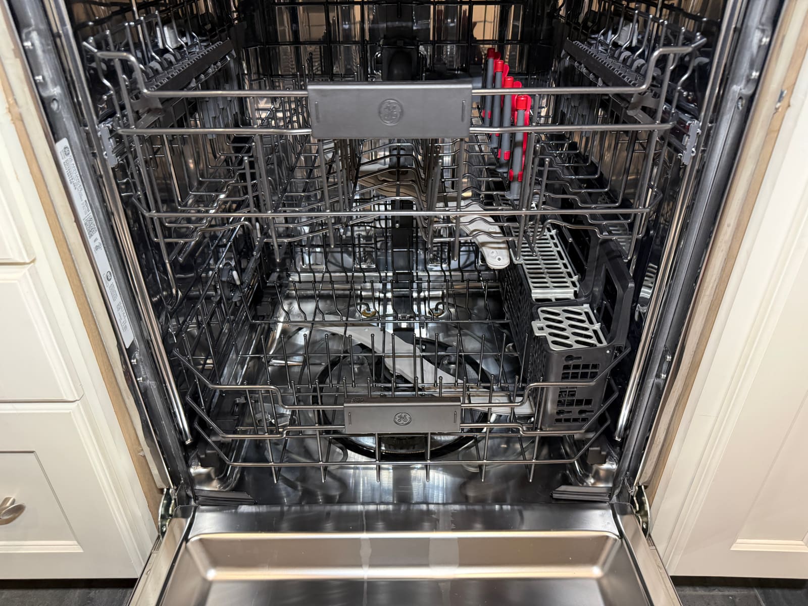 Interior of the GE dishwasher looking unused and like new despite being over five years old