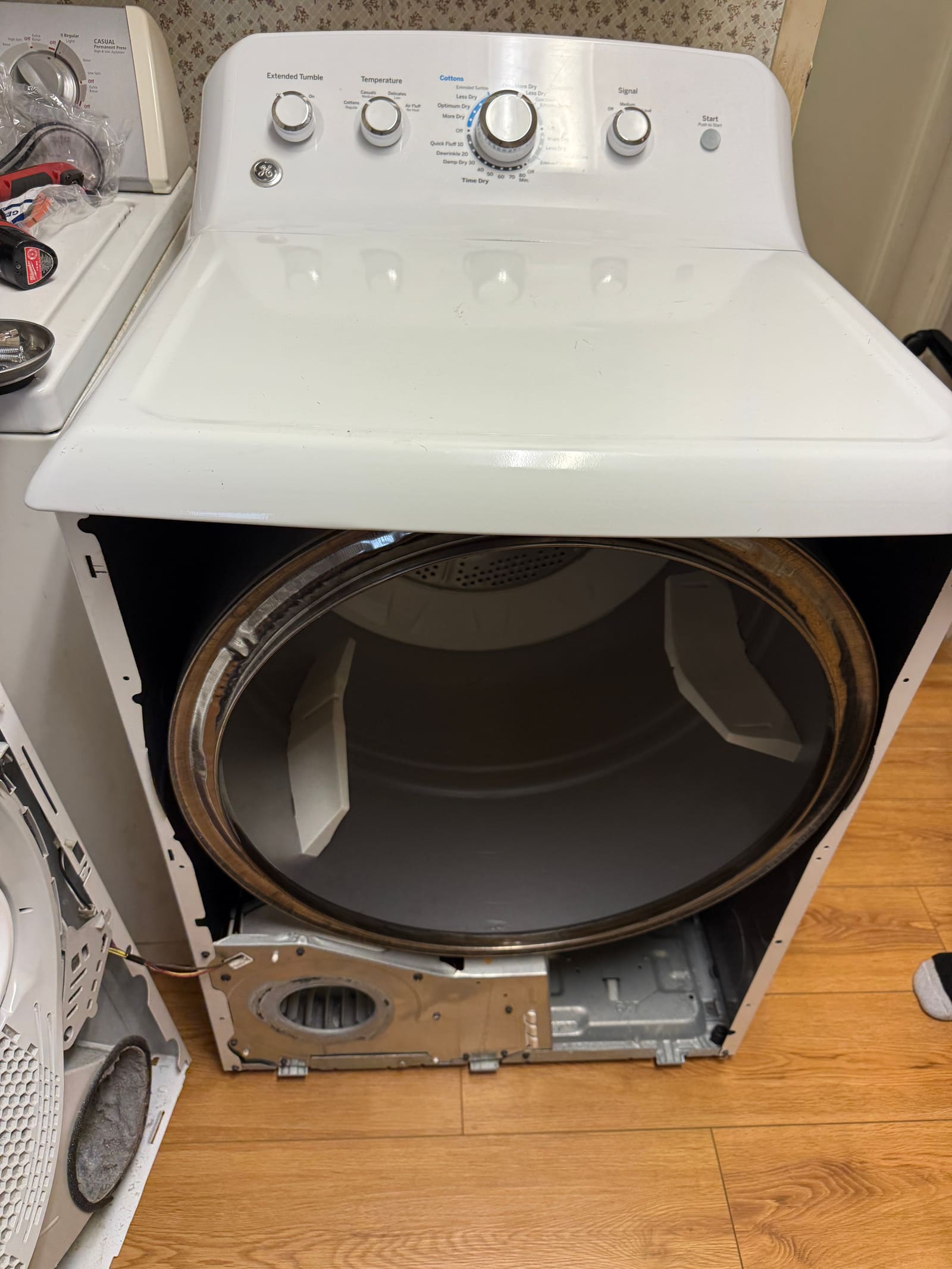 GE dryer opened up, exposing the drum and rear panel