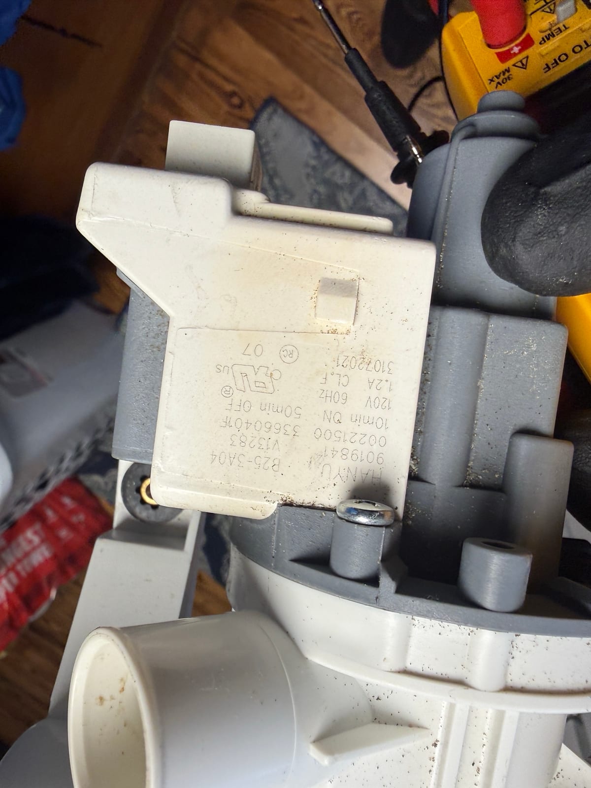Label on the old drain pump showing 120 volts, 60 hertz and 1.2 amps