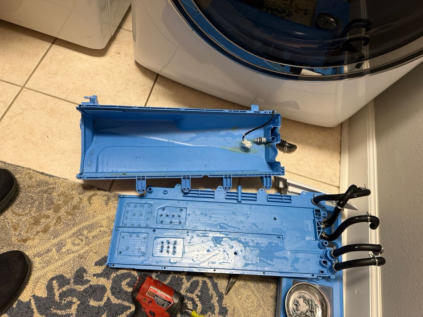 The same GE dispenser housing after cleaning, shiny blue and free of residue