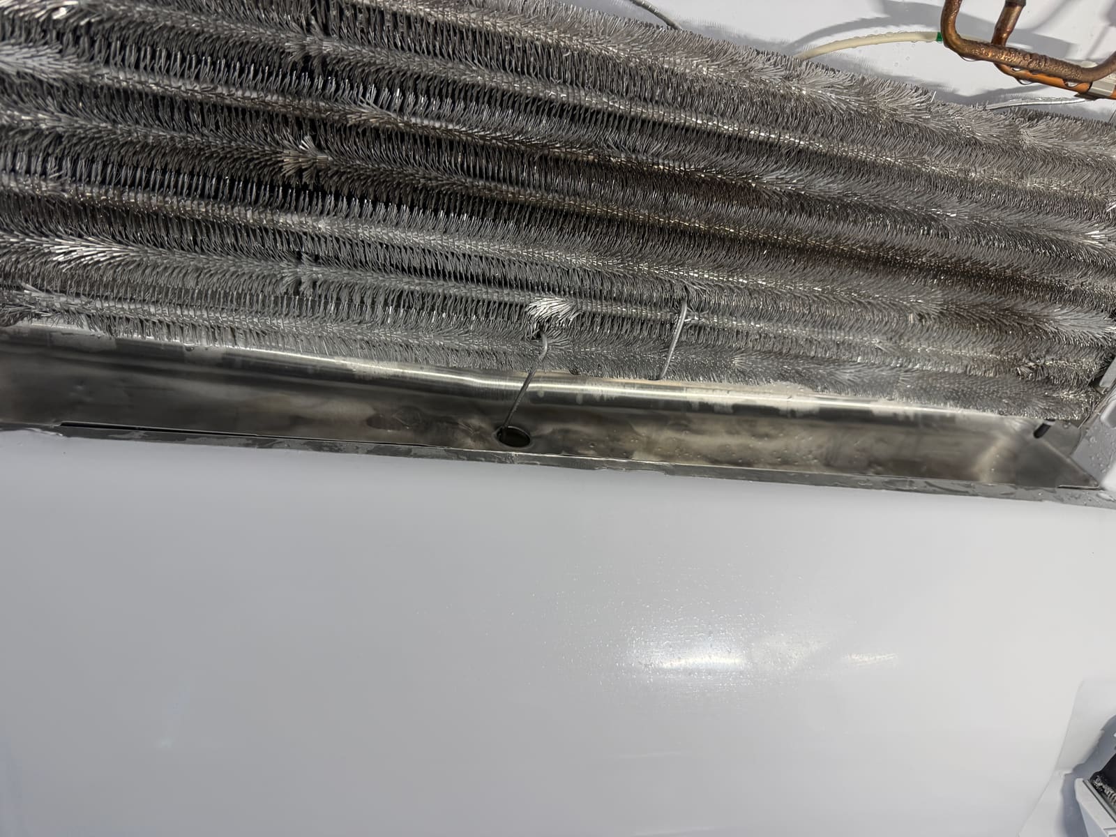Evaporator coil fins inside the freezer compartment, cleared of frost