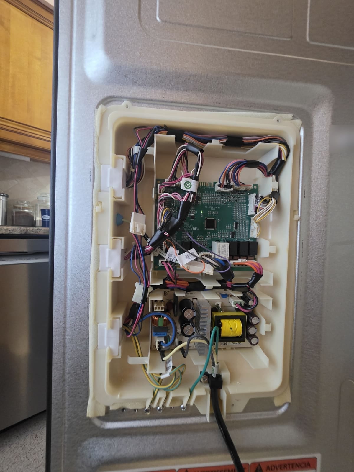 GE Profile refrigerator main control board and power supply board behind the rear cover