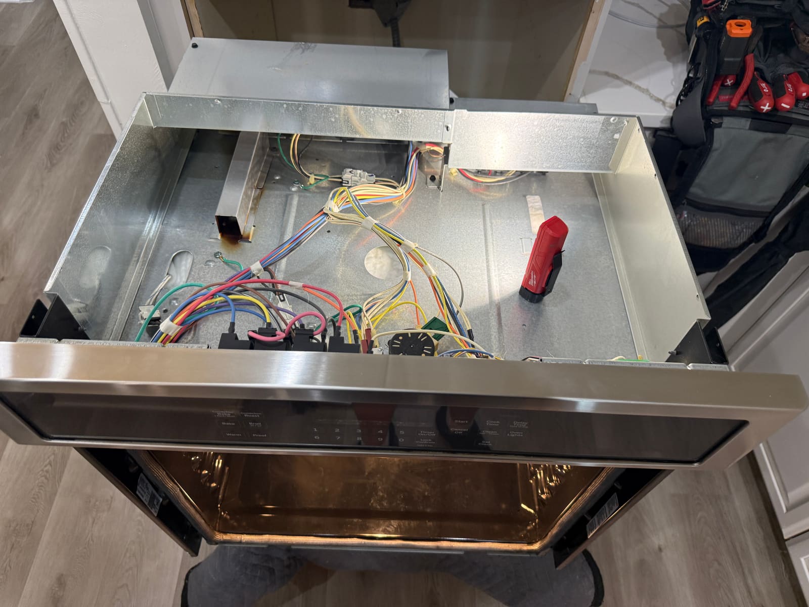 Wiring compartment on the GE wall oven pulled out to check incoming power