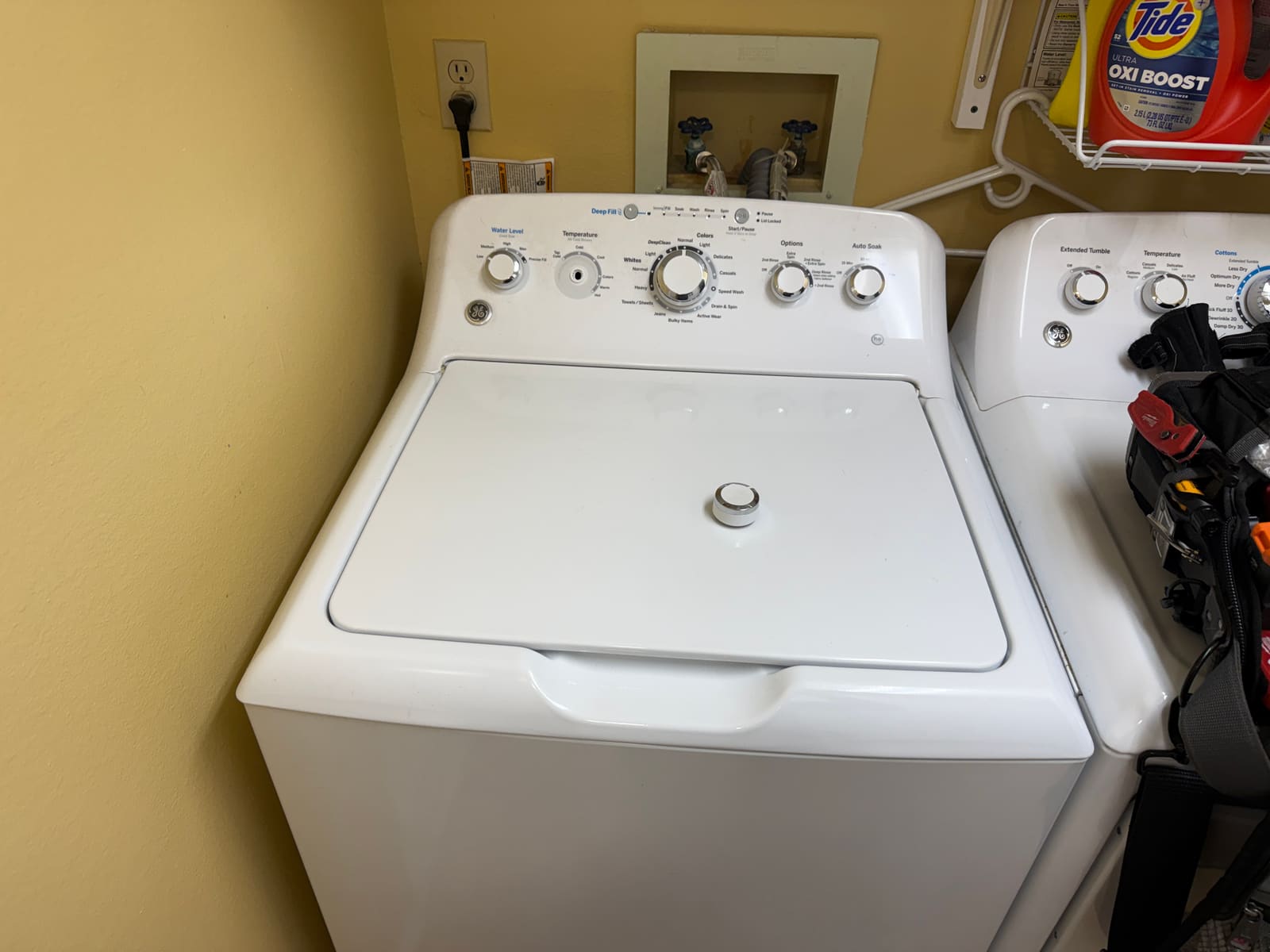 GE top-load washer and dryer set in a laundry room in Palm Harbor