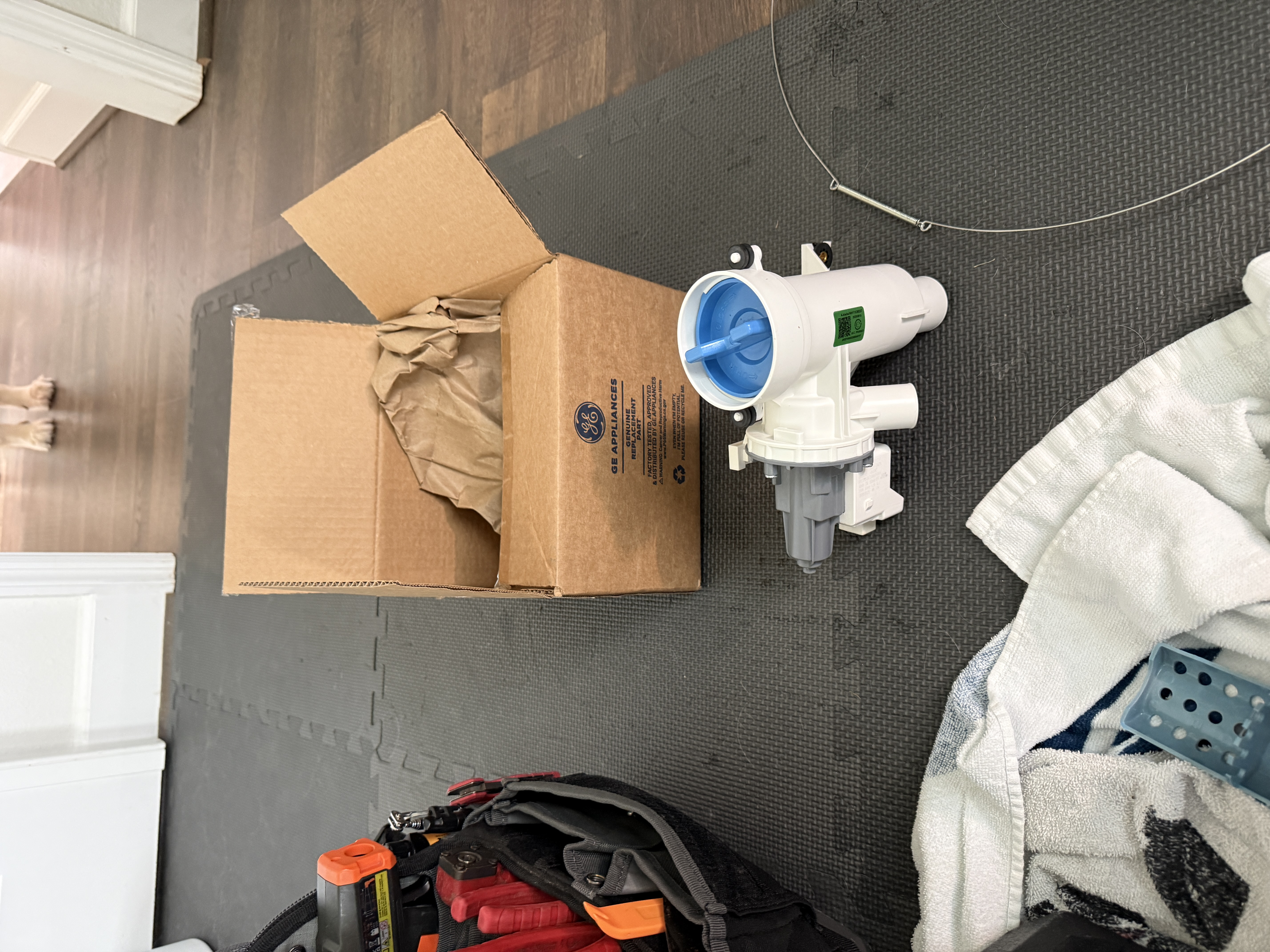 New GE genuine replacement drain pump next to the old seized pump