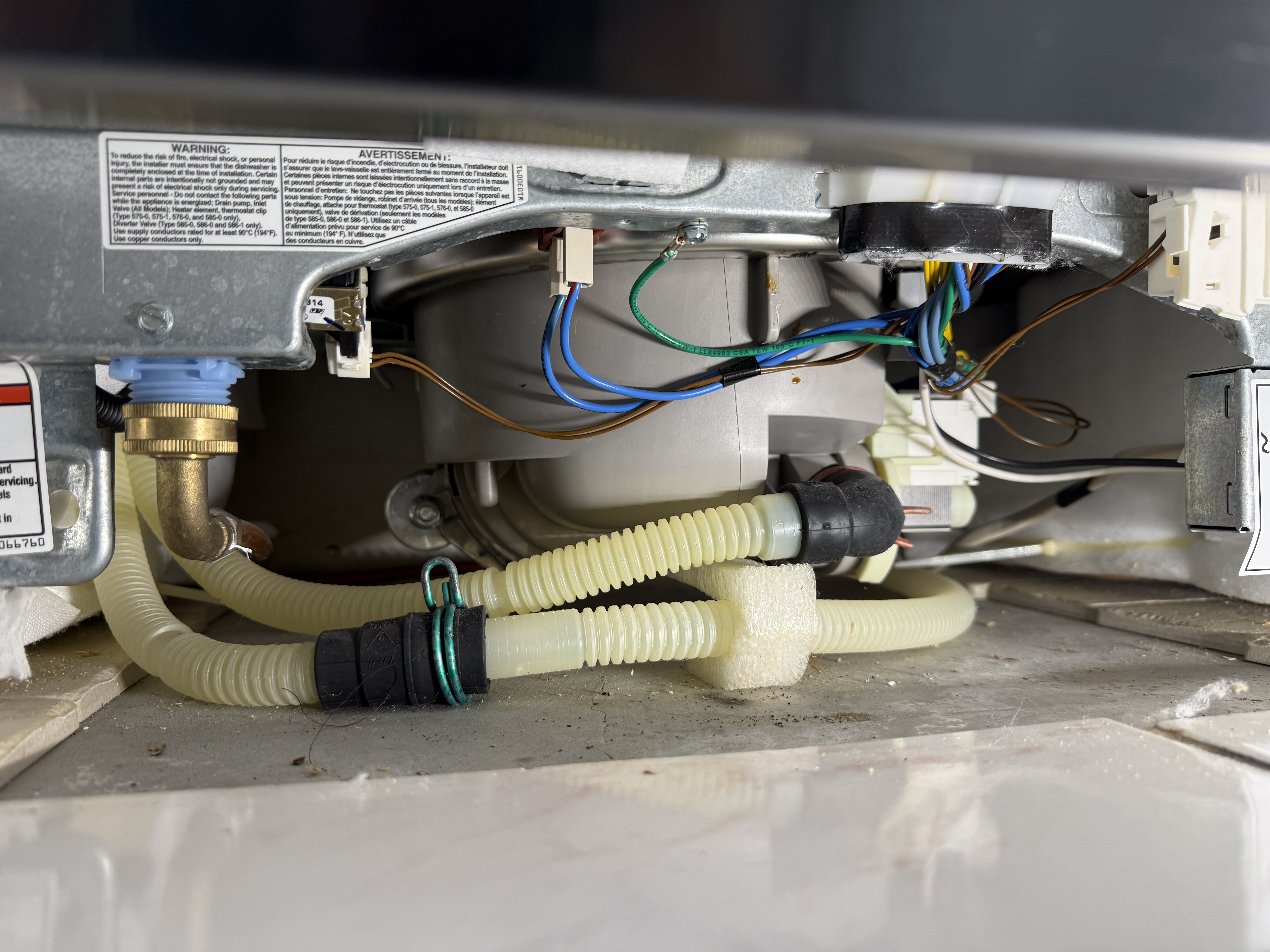 Underside of the KitchenAid dishwasher with components exposed for testing
