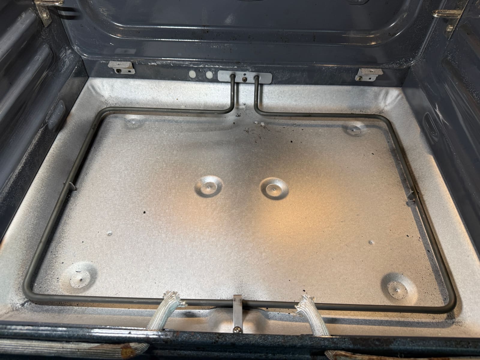 New bake element installed under the KitchenAid oven floor before the floor panel goes back in