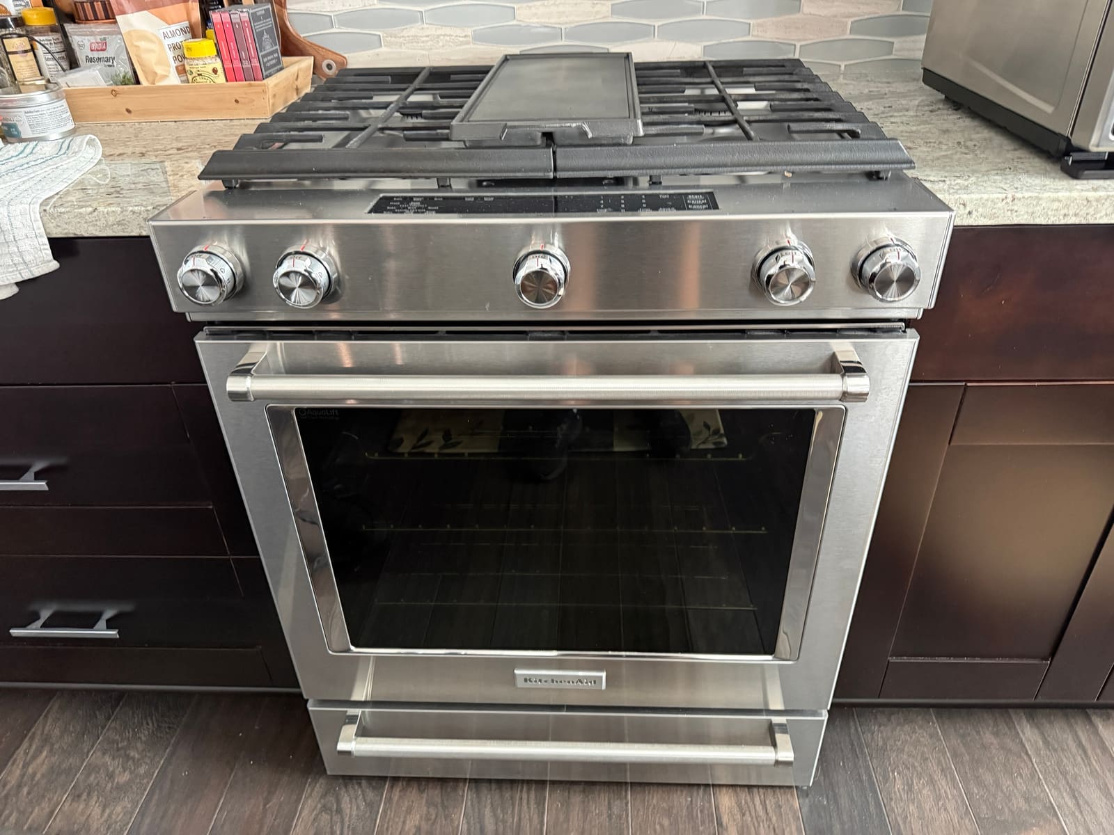 KitchenAid stainless slide-in dual fuel range with gas burners and a griddle in a kitchen in Westchase