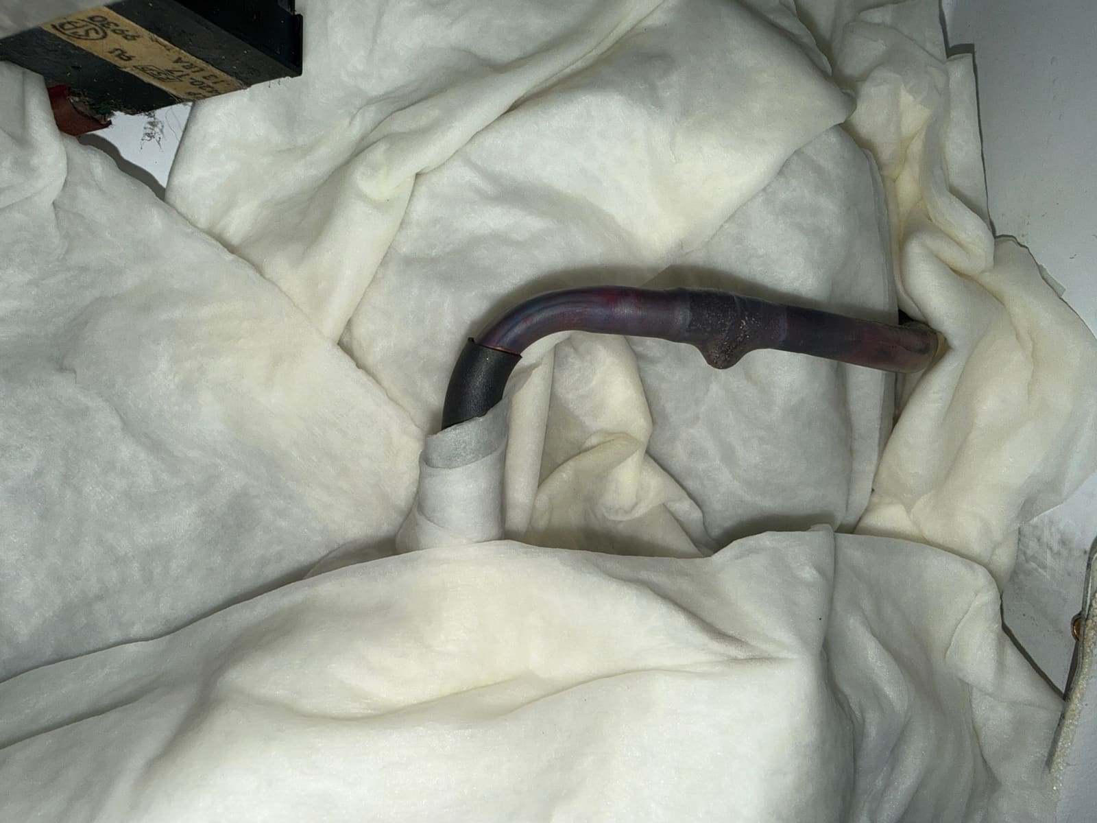 Second brazed joint on the evaporator line, insulated and ready to close up