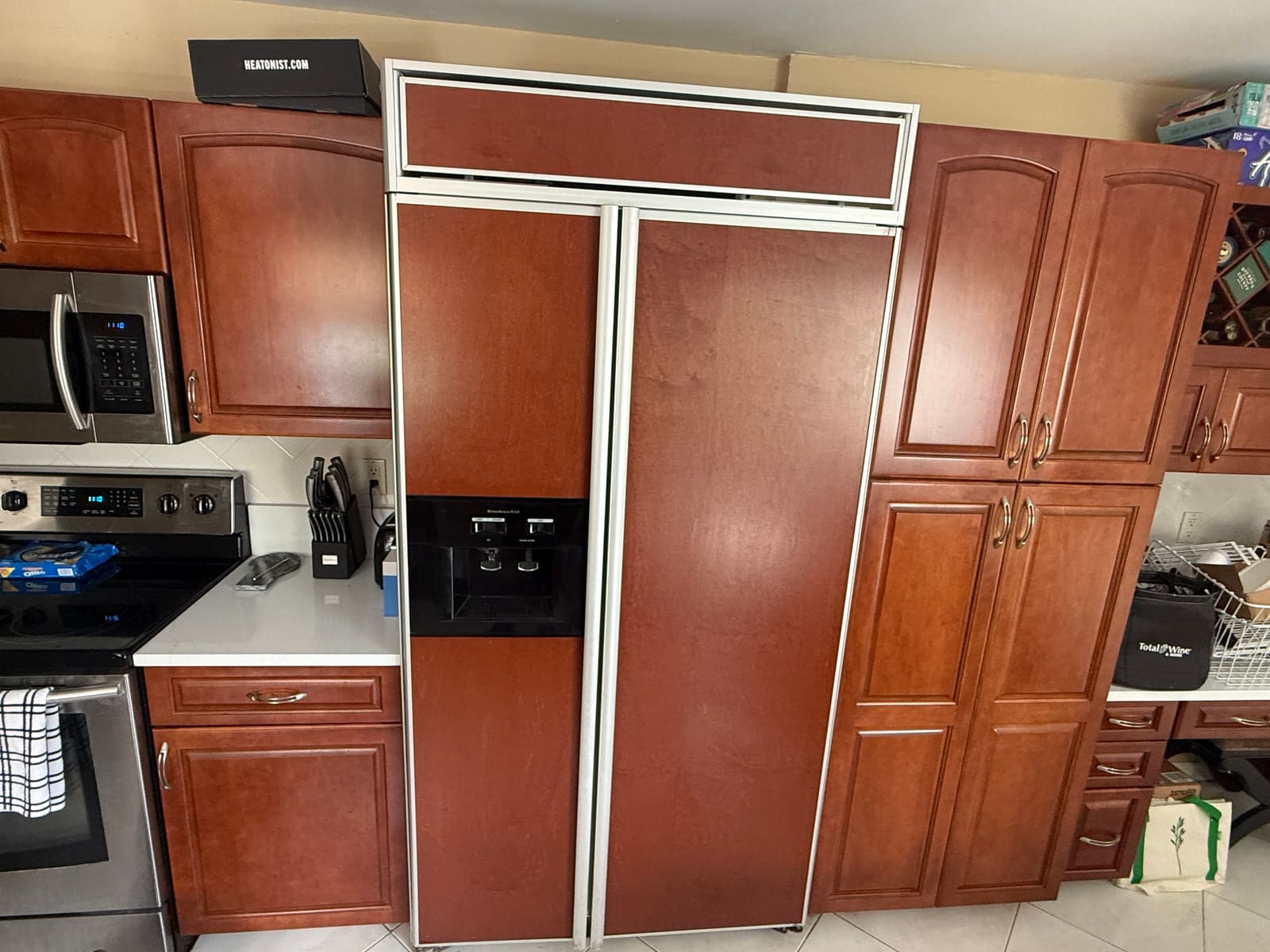 Built-in KitchenAid refrigerator with wood panel fronts in a kitchen in Safety Harbor