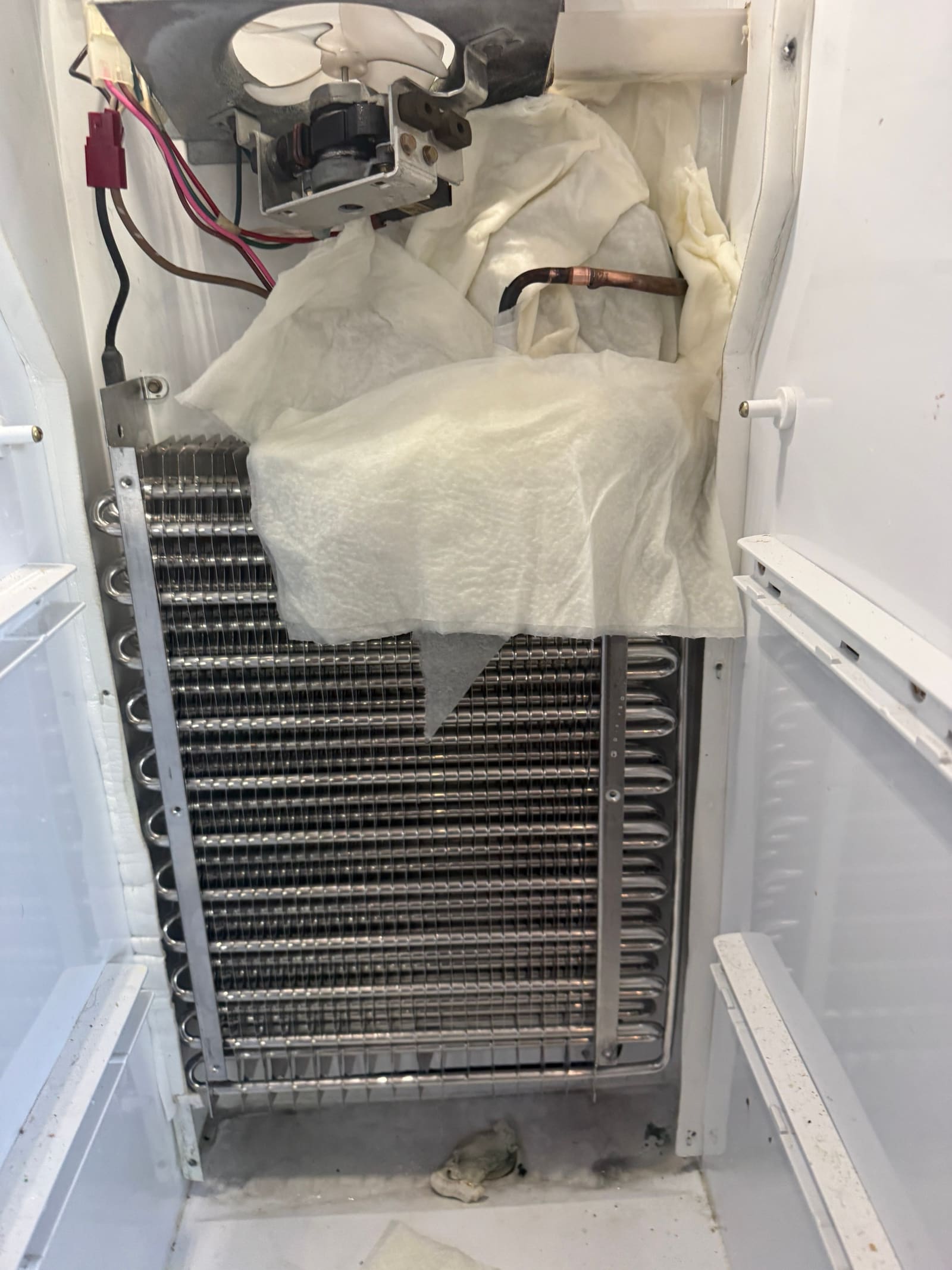 Old leaking evaporator coil next to the new replacement evaporator