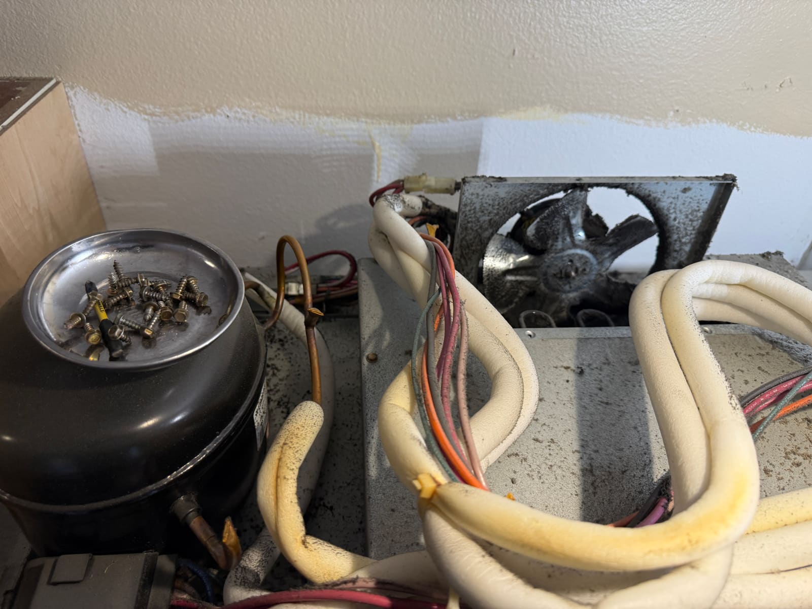 Dusty condenser fan area on the KitchenAid Superba refrigerator before diagnosis