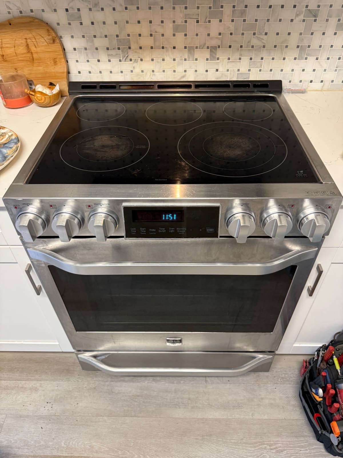 LG electric range with six control knobs and a pull-out warming drawer in a Strathmore Gate, Palm Harbor kitchen
