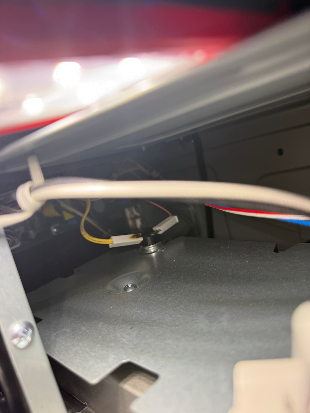 Close-up of the thermal fuse with scorch marks on its wire terminal