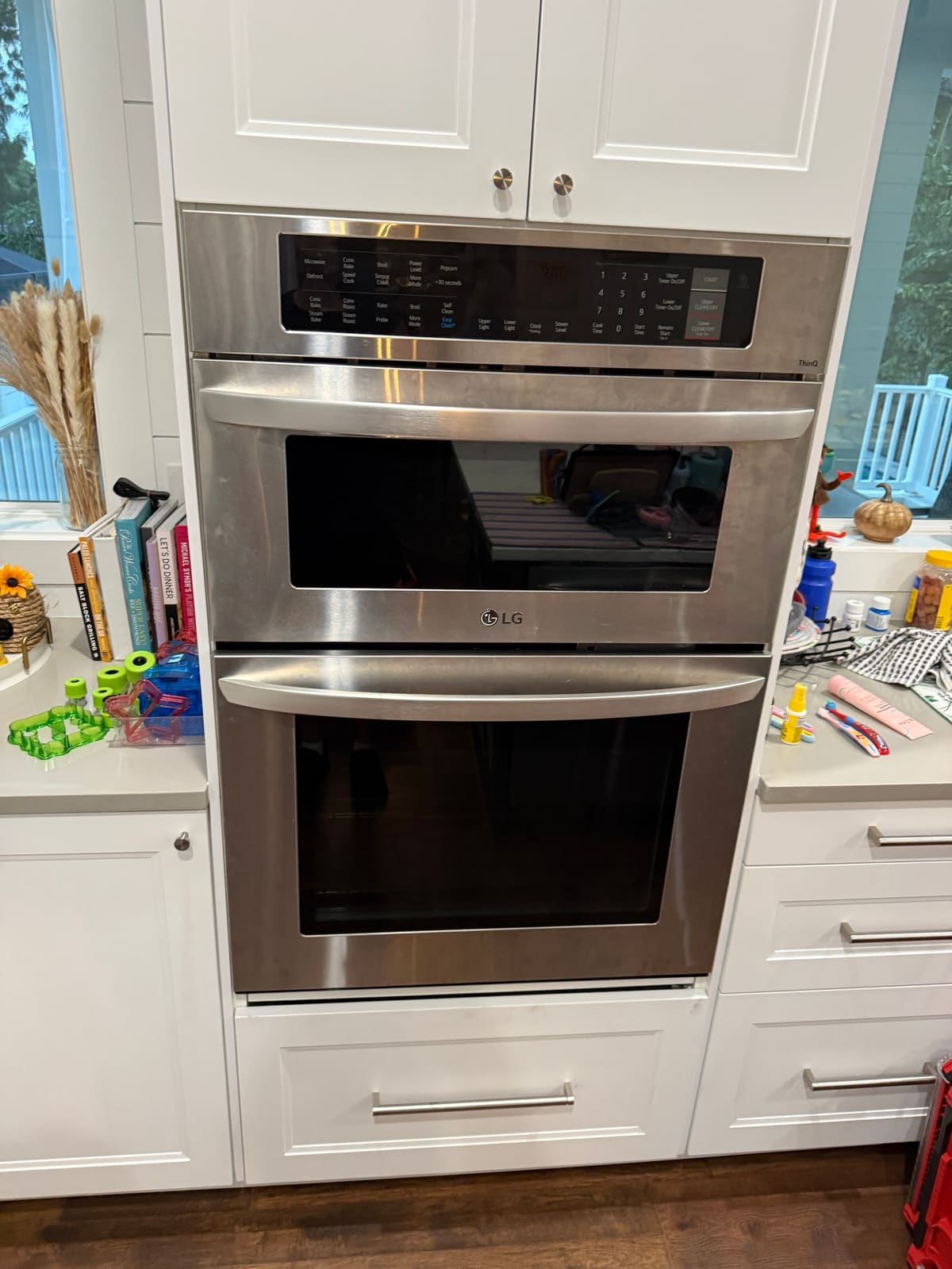 LG microwave and wall oven combo back in the cabinet with the display lit after the repair