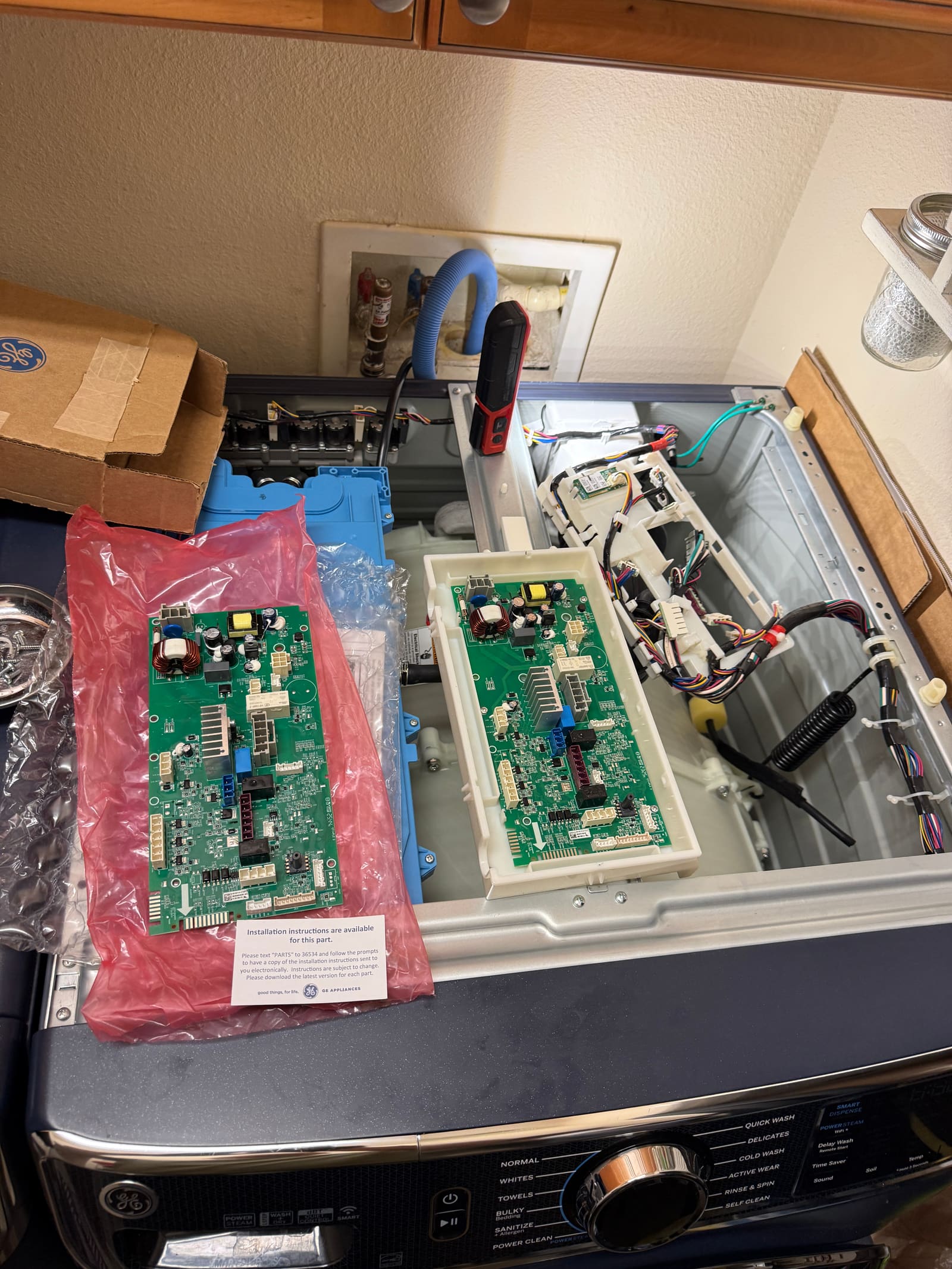 LG washer control board removed for replacement, with the new board ready alongside it
