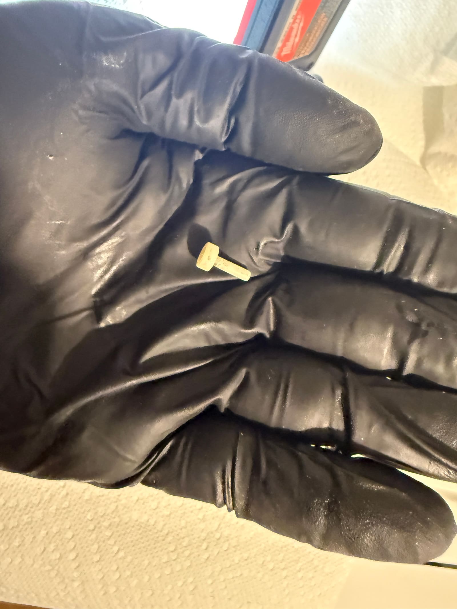 Piece of plastic debris removed from inside the washer's cold water bypass line