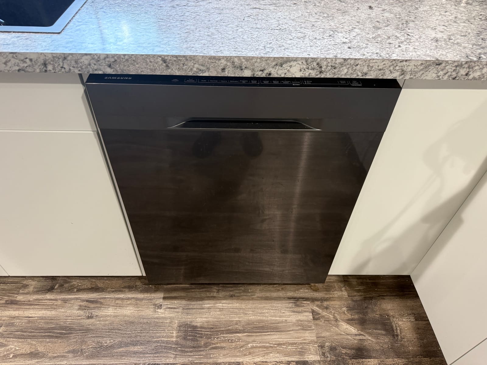 Built-in Samsung dishwasher with a black stainless finish in a kitchen in Palm Harbor
