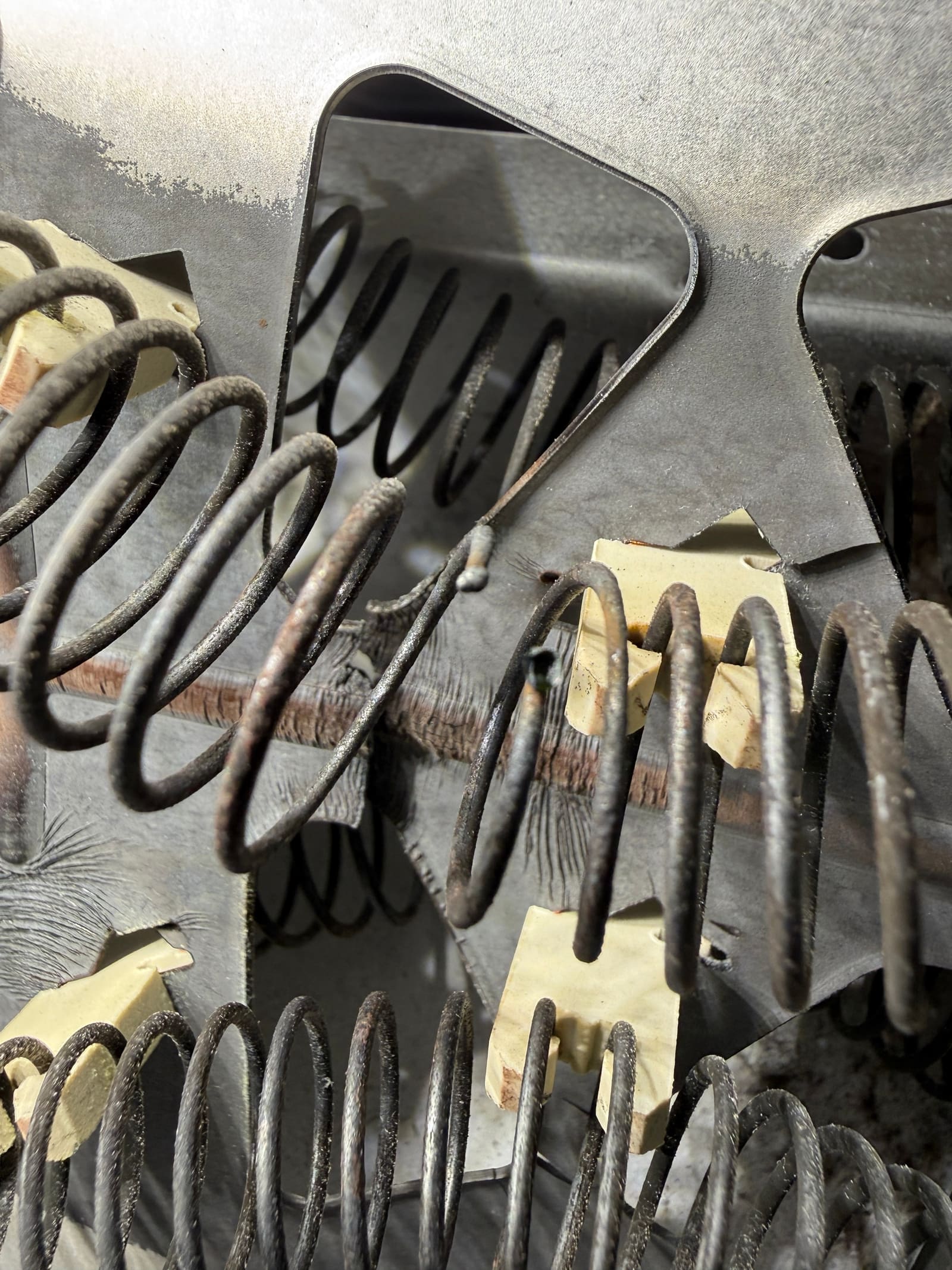 Close-up of the old heating element coil burnt through and broken