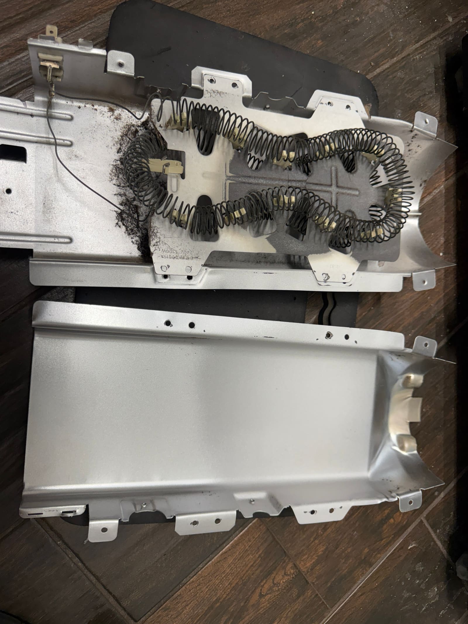 Samsung dryer heater can split open, showing the old heating element coil and scorch marks inside