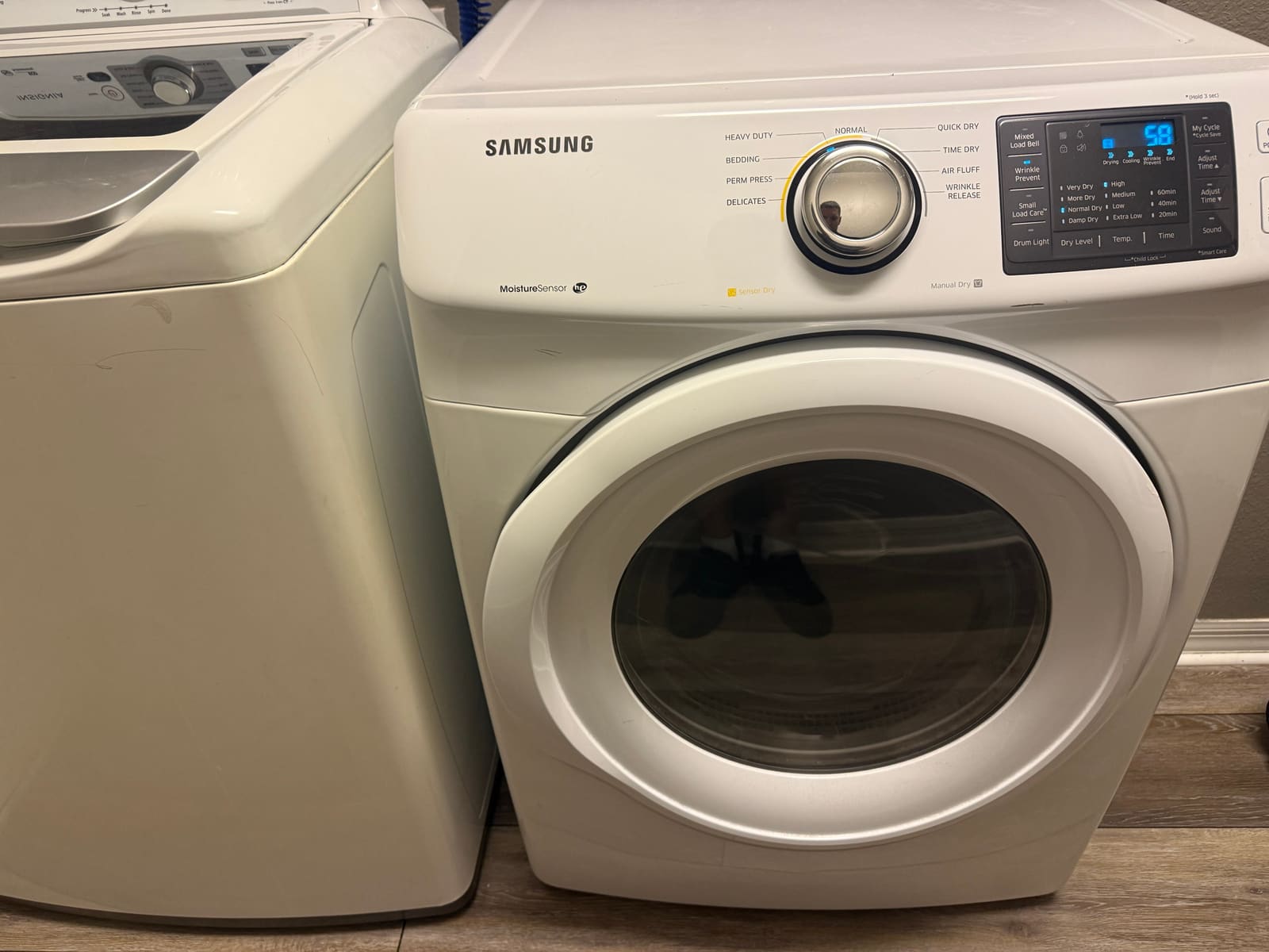 Samsung dryer next to a top-load washer in a laundry room in Westchase