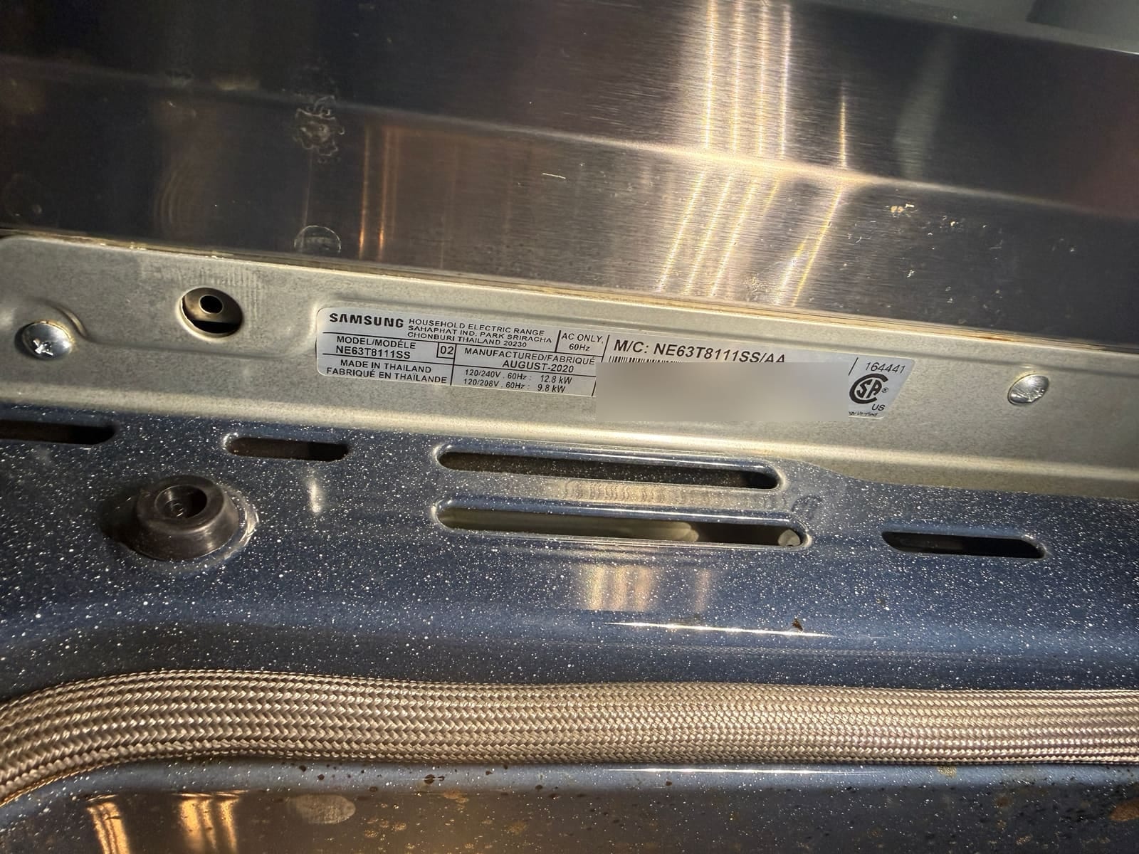 Samsung electric range data plate showing model NE63T8111SS, manufactured August 2020