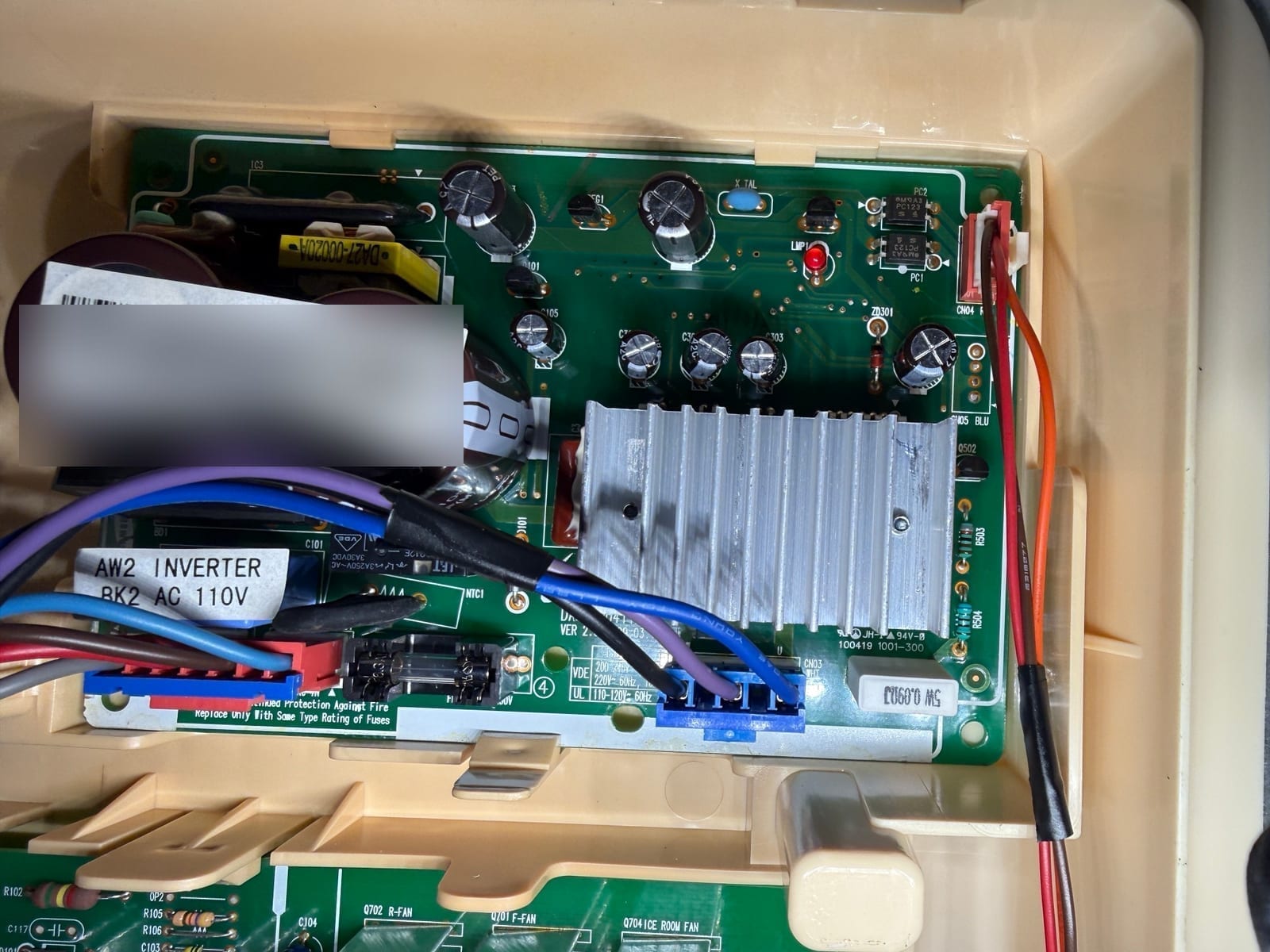 Samsung refrigerator inverter board, labeled AW2 inverter, with a heat sink, capacitors and the wiring to the compressor