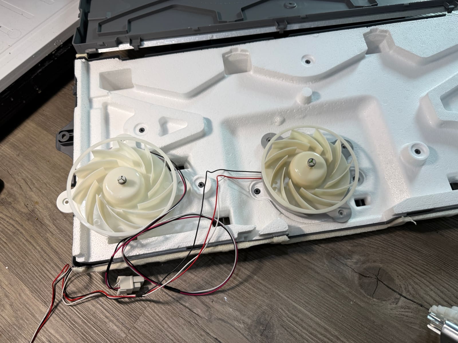 Samsung evaporator cover removed from the refrigerator, with two fans mounted in the foam