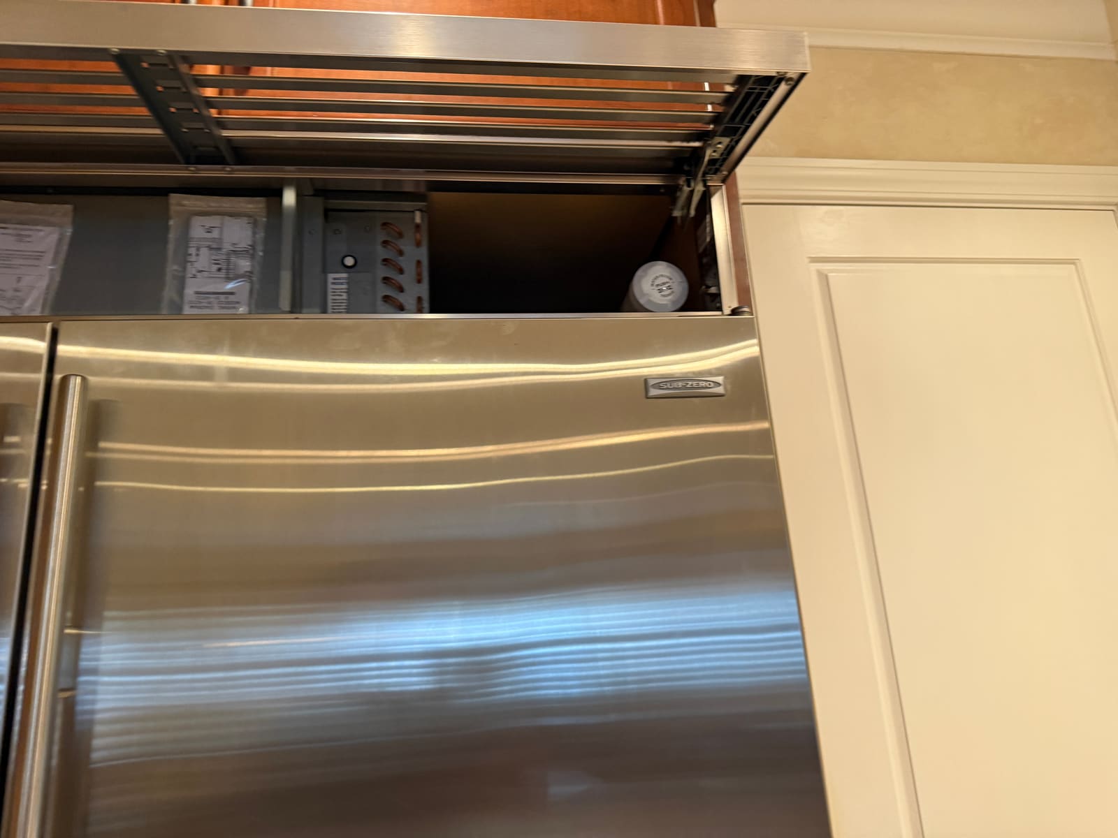 Close-up of the Sub-Zero refrigerator's service compartment during the repair