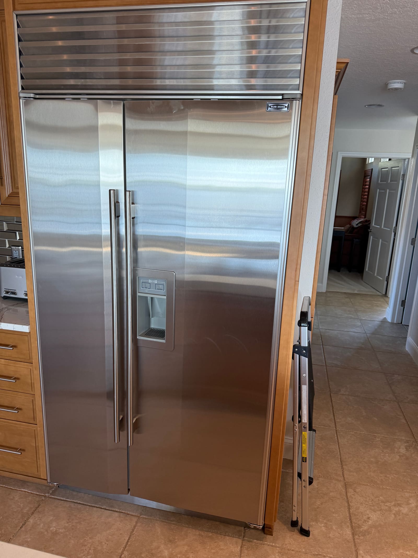 Built-in Sub-Zero refrigerator with bottom freezer drawer in a kitchen in Tarpon Springs