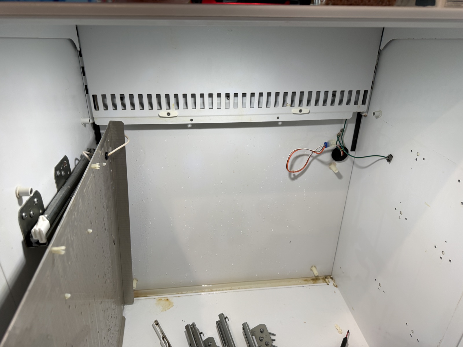 Sub-Zero refrigerator compartment in Clearwater with the shelves, drawers and inner panels taken out to reach the drain