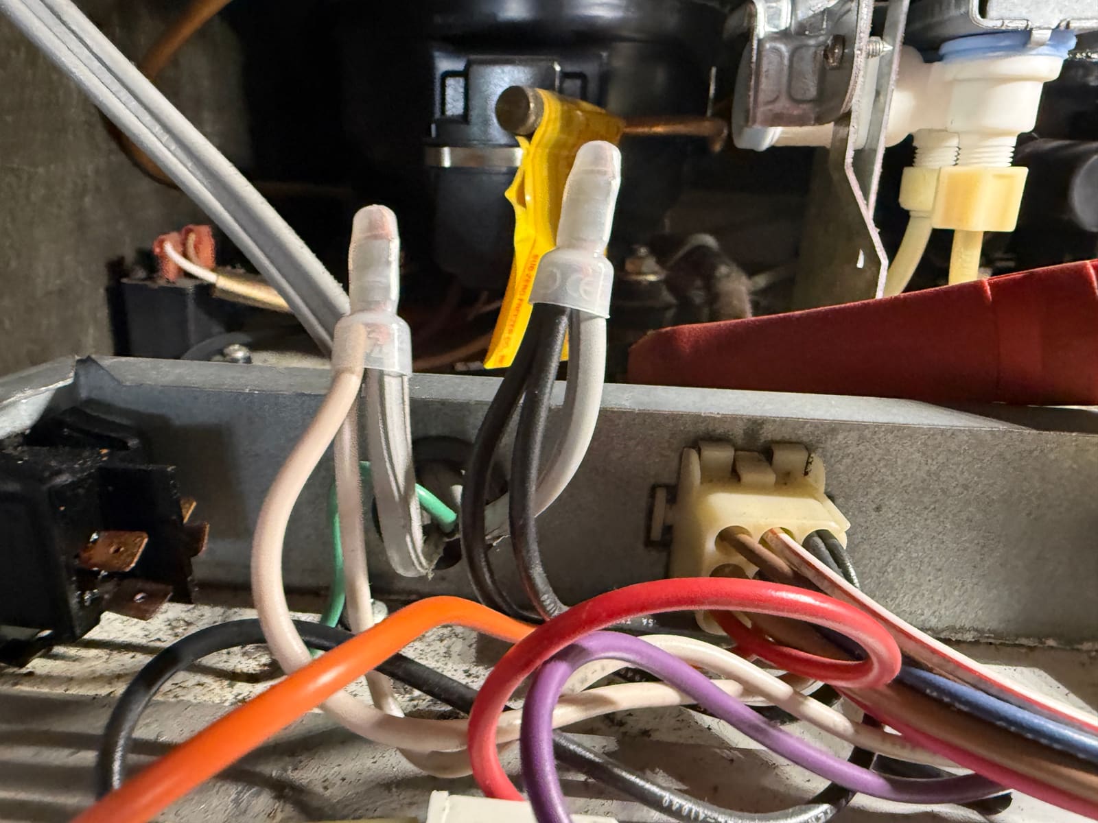 Power wires joined with insulated connectors next to the burned switch, which is disconnected on its bracket at the left