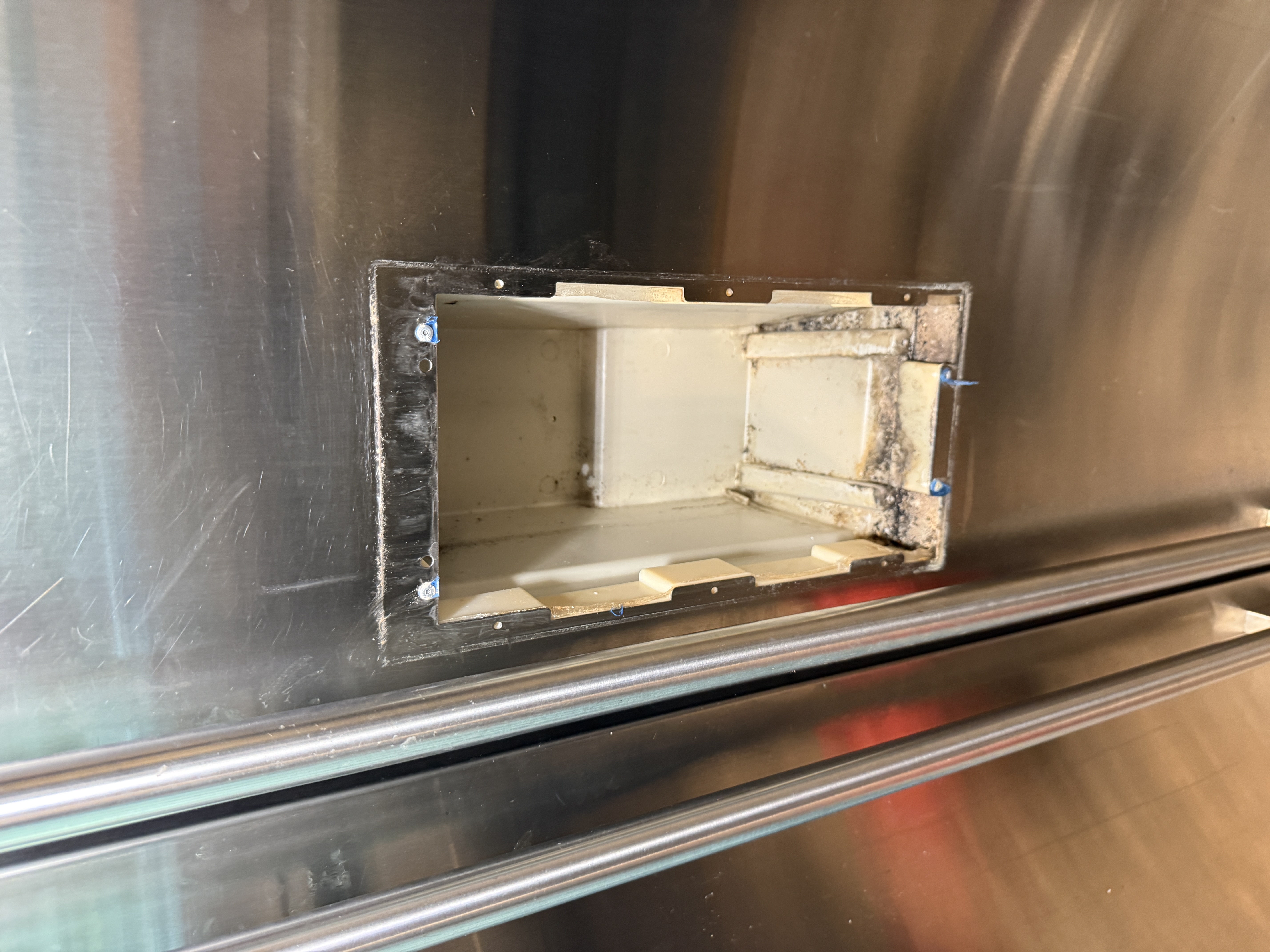 Dispenser housing removed from the Sub-Zero refrigerator door