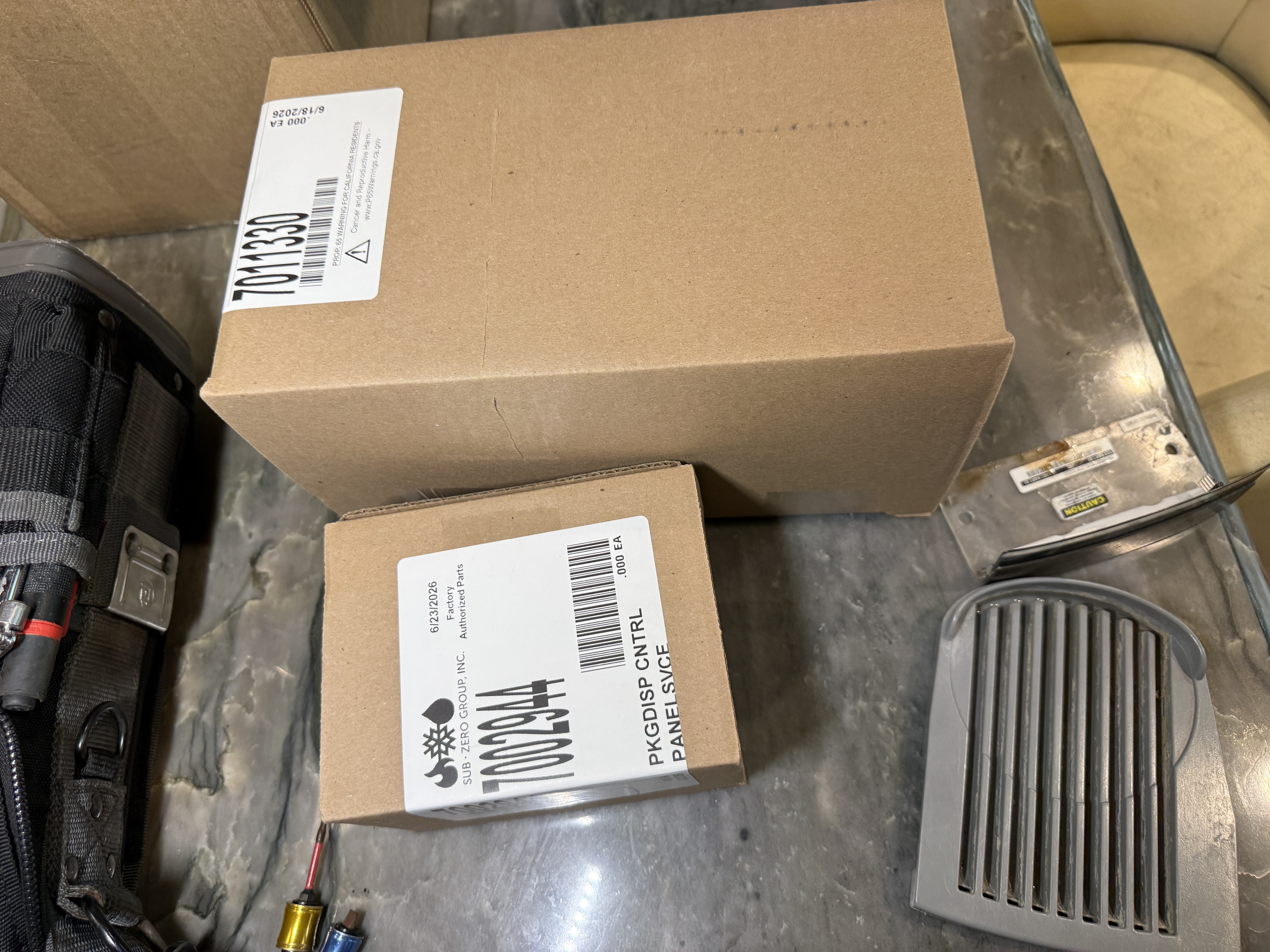 Sub-Zero factory-authorized dispenser control panel service parts in their boxes