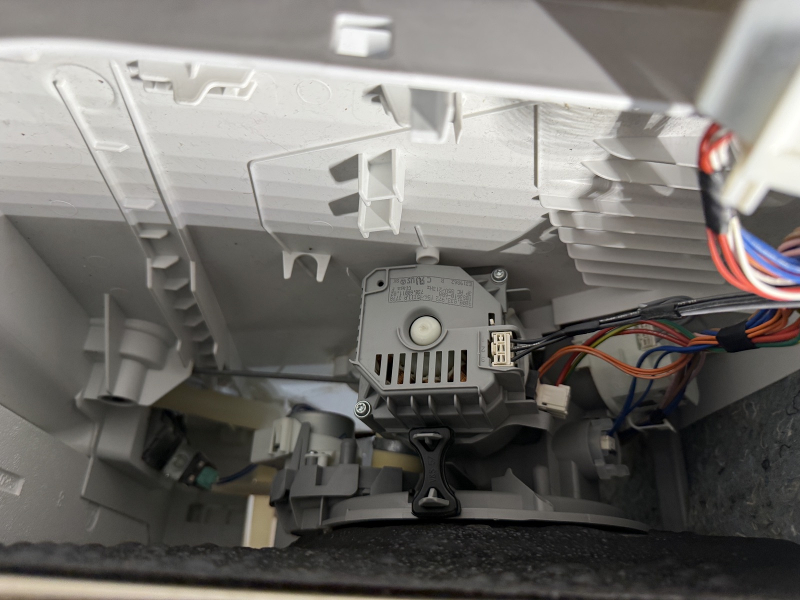 Underside of the Thermador dishwasher tub showing the pump and its wiring