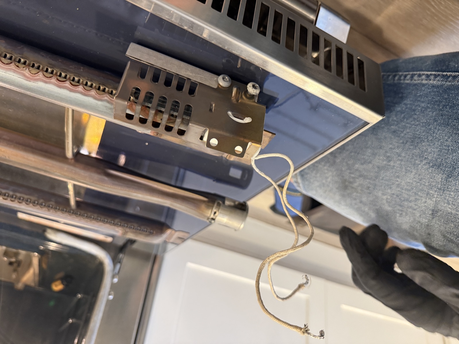 Bake igniter attached to the end of the oven burner tube, removed from the Thermador range