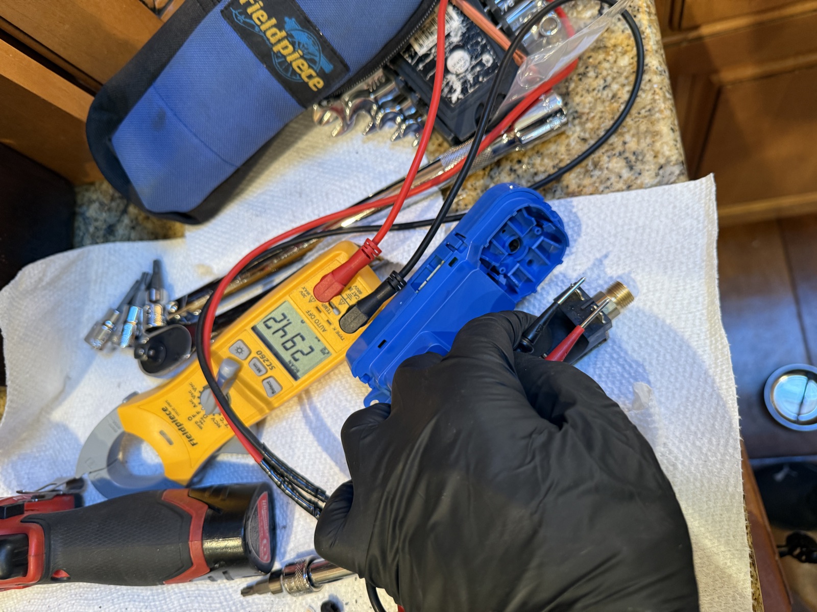 Burner valve from the Thermador range being tested with a multimeter